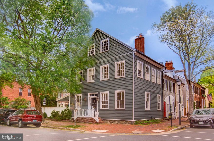 In the heart of Old Town Alexandria and only two blocks from the waterfront, 201 Duke St is an irreplaceable chapter of Old Town’s legacy.

Originally constructed circa 1790, the residence showcases timeless architectural features including original heart pine floors, intricate moldings, and two wood-burning fireplaces that anchor its storied charm.  

The entire home has been thoughtfully refreshed and restored with curated designer lighting, bespoke wall coverings throughout, and an elevated palette of interior paint selections—each detail chosen to complement the home's historic character while introducing a curated modern aesthetic.

With marble countertops, updated cabinetry and all-new hardware, the charming kitchen with garden views opens both to the covered side porch and to the show-stopping courtyard and patio. Come springtime, cherry blossoms adorn the yard—an enchanting and picture-perfect retreat in the middle of Old Town. The floor plan includes four bedrooms, three full baths and two half baths on 4 levels. Look for the sweet hidden room that could be a potential future walk-in closet, an upstairs laundry room or just a flex space. The lower level is a great pub style room with a beautifully designed wine cellar, perfect for both quiet evenings and stylish entertaining.

Truly one of the most beautiful homes in Old Town, this rare offering captures the essence of old-world charm paired with impeccable, modern sophistication. Bathed in natural light on three sides with only one party wall, this exquisitely restored historic townhome offers a rare blend of 18th-century elegance and refined modern living.