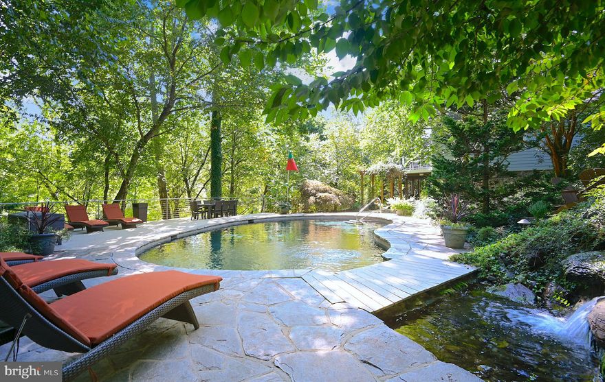 Stunning one-of-a-kind home on rarely available private double lot at the end of a cul-de-sac in the conveniently located, gated community of Washingtonville.  A must see with all the bells and whistles including an elegant 1st floor primary bedroom suite that features two large walk-in closets with custom built-ins, coffered ceiling, access to three-season screened porch and primary full bath that includes a double vanity, jetted soaking tub and separate shower with steam option.  The 1st floor also features a large family room with gas fireplace that adjoins a chefs kitchen with high end stainless steel appliances, breakfast bar island, granite countertops and opens to an oversized deck for outdoor entertaining.  A living room, dining room and butler's pantry complete the main living area.  Three more luxurious bedrooms upstairs, two of them "en suite". The fully finished lower level has a fitness room that provides access to the recently renovated in-law suite which includes a bedroom, full bathroom, living room and kitchen.  The outdoor space is not to be overlooked. Spacious deck with incredible views adjoins a light filled three season screened porch, stone patio, koi pond and gardens that are a feast for the eyes and an incredible in-ground pool, hot tub and pool house.  This property is the perfect retreat for pure relaxation!