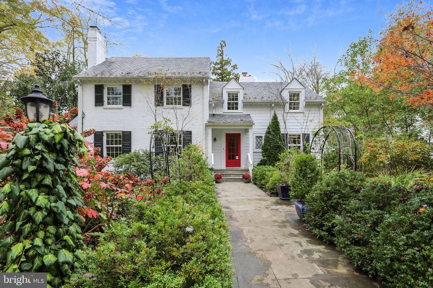 New to market!  This New England style Colonial is situated in a beautiful, private setting with award-winning gardens on a prime one acre lot.   A perfect home for those looking for loads of charm and character without having to sacrifice space or a floor plan suited to everyday living.  For history buffs, the property was formerly on the edge of the Bannockburn Golf Club which turned into the neighborhood of Bannockburn Heights.  This home boasts a recently renovated gourmet Kitchen in 2018 that opens to a large Family Room featuring a gas fireplace, built-in cabinetry and Powder Room.  The mahogany paneled Living Room enjoys a wood burning fireplace, adjacent bar area and a second Powder Room.  The Dining Room offers a classic wood burning fireplace leading to a lovely Sun Room which opens to a walled English Garden patio showcasing an inviting fountain trickling into a small pool.  The patio walkway path leads to a second covered porch with porch swing located off the Family Room.   The rear entrance Foyer with brick flooring is a perfect Mud Room and the adjacent Office can be used for any of your work or hobby needs.    The upper level includes a delightful Primary Bedroom Suite with a wood burning fireplace and a magnificent Bathroom with an oversized frameless glass shower, two walk-in closets, separate water closet and a reclaimed wood vanity topped with stone.  The second Ensuite Bedroom has a renovated Bath with a frameless glass shower and stone surfaces.  There are two more Bedrooms and an updated hall Bath.  On the grounds, there is a separate Cottage with full Bath that is currently used as a second Office but could be private living quarters.  The garden and grounds are breathtaking with rose-covered arbors and a wrought iron gazebo, flagstone pathways meander through numerous garden beds featuring  specimen plants, peonies galore and flowering magnolia trees.  The lawn area is large enough for soccer games or a possible future pool.  The circular driveway graces the front entrance and an additional driveway accesses the over-sized garage and rear entrance of the home.   A superior location close to downtown Bethesda, the C&O Canal, shopping and schools in the Whitman cluster.