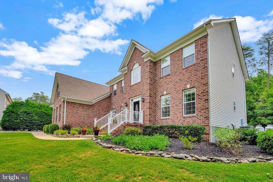 Enjoy a quiet country setting < 5 minutes from I 95. (Commuter's Dream- 2.9 miles (6 min) to Commuter Lot,  20 miles (24 min) to Quantico,  and 48 miles (45 min to Pentagon ). This extraordinary Artbuilt home  ('A'  Rating in Construction Quality per RPR) reflects commitment to craftsmanship, style, comfort, quality, and exquisite details. This home has a beautiful, quiet, serene setting with a private wooded view (front and backyards). This stately abode  sits on just over an acre on a Cul de sac in prestigious Mansfield Manor. The charm begins as you pull into the driveway with Gorgeous Landscaping, Seasonal Flowers and Bushes, Low Voltage Exterior Lighting on Timer, PLUS Decorative Rock Border and Maintenance Free Rubber Mulch on all Islands and around perimeter of house...........
As you step into the foyer, you are greeted by a Grand Staircase that makes a striking visual impression along with the soothing neutral color palette. The living and dining rooms have Gorgeous, Intricate Ceiling and Wall Molding. The spacious dining room is ready for hosting those special occasions and creating lasting memories. That is just the beginning........The Gourmet kitchen boasts Granite counters, Backsplash, Newer SS double sink, Plenty of Cabinet Space,  SS Double Wall Oven (Brand new), Cooktop (Brand new), Wine Rack, SS appliances, Large Kitchen Island, Exquisite Pendant Lighting, and Newer Microwave (1/23) and Fridge (12/22). Storage will never be an issue with the abundance of cabinets and Oversized Walk in Pantry (12' x 8'). The kitchen opens to the large family room with One of a Kind Ceiling Molding. This is a comfortable space to relax, watch TV, or chat with family and friends. The gas log fireplace with Custom Stone Work is perfect for taking the chill out of the air or ambiance. To complete the main level is a powder room (with Bidet), Mud room, and an Office with Custom Lighted Display Cabinets!!!............ Take 1 of 2 Staircases to the upper level. Here you will find 4 bedrooms, of which 2, are attached by a Jack and Jill Bath with Double Sinks. Another bedroom is an Ensuite! All bedrooms have Walk in Closets! The spacious Primary bedroom has a Sitting area and 2 walk in closets. (1 closet is currently being used as a workout room). The primary bath has been remodeled with a larger shower, stand alone tub, large vanity with double sinks, granite counter, and ceramic tile flooring. The shower fixtures are from Fergusons and "never seal" grout was used in the shower and floor. To complete the upper level is the laundry room with a Utility sink........This home is sure to entertain guests and family with an impressive Billiards/ Game Room and Movie Room. There is a Full Bath and Plenty of Storage in basement area. The Movie room has a 90" HD screen and 6 theater seating Recliners......Bring the party out to the Deck and Stamped Concrete Patio (evening shade)...OR have your morning coffee or evening cocktail as you take in the serene private backyard setting........Did I mention there is a built in 12Kw Generator? Don't miss the 3 Car Garage with painted walls and ceiling along with floor. No HOA. HVACs serviced/ inspected semi annually. See Listed features sheet in docs for more info and conveyance items.
Room sizes are approximate. Camera on doorbell and side of house. Tax record SF appears incorrect. Bath, rec room, alcove, and movie room approx 918 SF. Total basement SF 1945. ( unfinished portion should be 1047 approx) Click on movie icon for Virtual Tour of home and Video of Neighborhood! More info regarding house in my Documents.- Plat, Listed features, etc