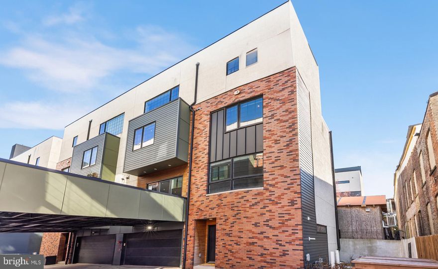 Welcome to 1124 Shackamaxon St #8, a luxurious haven nestled in the vibrant heart of Fishtown and crafted by the esteemed local developer Roland Kassis of Kassis Ventures.This exceptional end-unit boasts an extra-wide layout, offering unparalleled comfort and style in one of the city's most coveted neighborhoods. Conveniently accessed via a super-wide driveway just off Frankford and Girard Avenues, this home presents an enviable feature: a private 2 car garage, ensuring both security and convenience in urban living. Upon entering the spacious foyer, you're greeted by two generously sized coat closets and a conveniently placed half bathroom, setting the tone for effortless living. Ascend to the main living area, where an abundance of natural light floods through the oversized windows, illuminating the open-concept living, dining, and kitchen spaces with soaring 10’ ceilings. Here the sleek white Quartz countertops and top-of-the-line Bosch and Samsung appliances adorn the modern kitchen custom-designed by Spogue Kitchen, while tri-fold piano glass doors lead to a private deck seamlessly integrating the indoor and outdoor living spaces. This ideal retreat is ready for relaxation and entertainment. Continuing upwards, discover two spacious bedrooms adorned with custom closets, a full bathroom featuring dual sinks, and a practical walk-in laundry room complete with a sink for added convenience. The pinnacle of luxury awaits on the next level—the primary suite—where soaring modern industrial windows bathe the room in sunlight, complementing the custom-built walk-in closet and leading to a sumptuous ensuite. Pamper yourself in the luxurious primary bathroom, complete with radiant heated floors, a dual vanity, a designer soaking tub, and a spacious shower with two rainfall shower heads. For moments of serenity amidst the cityscape, ascend to your private rooftop deck—a tranquil oasis offering sweeping city views and endless possibilities for outdoor enjoyment. The large fully finished basement awaits with multiple storage closets that provide ample storage and additional flexible living space to suit your lifestyle needs like entertainment or an additional bedroom. Enhancing your living experience, this home comes complete with custom window treatments throughout, an EV car charger, and Lutron “smart” lights that are compatible with Alexa/Google, etc., seamlessly blending modern convenience with sophisticated design. Two additional parking spaces are located in front of the home for day time use only. A side yard provides even more outdoor space for your enjoyment. This modern home is a few blocks from PlayArts, Fishtown Montessori School, and is in the Adaire School district. Proximity to Penn Treaty Park, Palmer Park and the Delaware River waterfront offer easy access to green oases in the city. Fishtown offers a vibrant array of dining, entertainment, and shopping including Suraya, La Colombe, Kalaya, LMNO, Middle Child Clubhouse, Pizzeria Beddia, Fishtown Seafood, Johnny Brendas, and so many more. Plus Northern Liberties and all it has to offer is in close proximity. Easy access to the Market-Frankford train line, commuting downtown or to 30th Street Station, or hopping onto I-95 is a breeze. If all that wasn’t enough, there are 4.5 years left on the tax abatement. Don't miss the opportunity to make this extraordinary residence your next home. Schedule your viewing today and embark on a journey of luxury living in the heart of Fishtown.