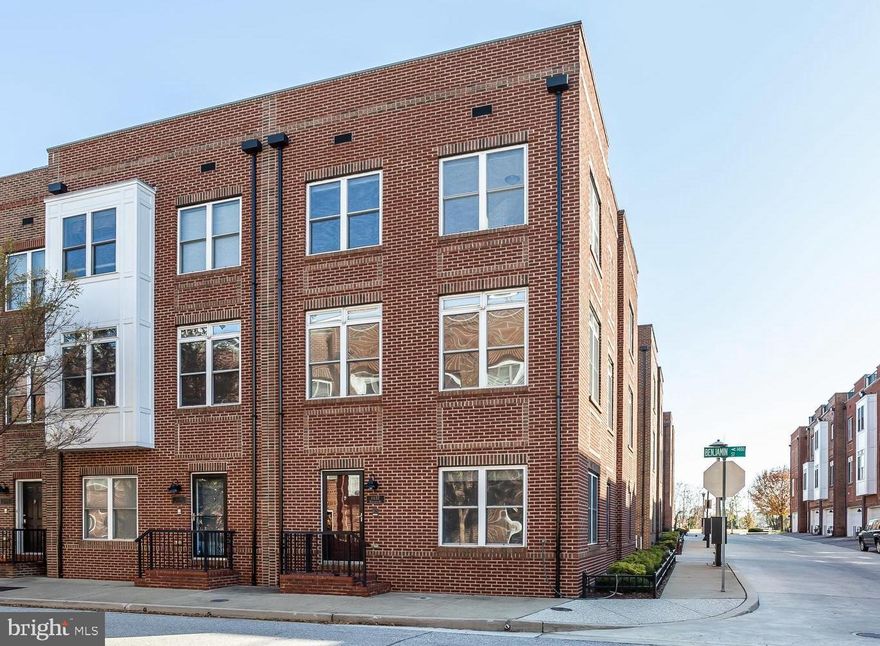 Light-filled, end-of-group  garage townhome in McHenry Point!  This 20 foot wide home's main living level offers an open floor plan with a large dining and living room featuring hardwood floors, custom moldings, and gas fireplace.  The gourmet kitchen is appointed with stainless steel appliances, granite, and an island.  Adjacent to the kitchen is a bonus room that offers additional table space or a casual living space.  Upstairs you will find the bedroom level, which includes the master suite, two guest bedrooms, and a guest bathroom.  The master suite offers a large bedroom that can accommodate a king size bed,  an over-sized walk-in closet, and a private bathroom.  Up top you will discover a wet bar with fridge in the penthouse that leads out to a massive roof top deck.  The entry level of the home includes an office/guest bedroom, half bath, laundry & 2 car garage.