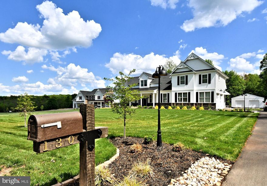 Looking for new construction but don't want to wait? Welcome to this One-Of-A kind Custom Designed Home. This extraordinary property sits on 2.62 acres backing to lush woods. This stunning home is also perfect for Multi Generational living, extended family and caregivers, while offering a perfect blend of elegance and comfort. Providing ample space for both relaxation and entertainment. This home boast 4000 square feet of living space and ensures plenty of room for family and guests. Upon entering, you are greeted by a two story foyer filled with natural light that welcomes you to the open floor layout that flows seamlessly from room to room. Whether you're hosting gatherings or enjoying a quiet evening, this home caters to all your needs. On the main level off the foyer is a nicely tucked away home office with double doors for privacy while working. Also a large coat closet and powder room. As you enter the main room you are greeted by gleaming hardwood floors and  reclaimed hand made Hemlock Beams, which are strategically placed above hallways and used to divide the living rom from the kitchen. The living room is open to the kitchen which creates ease for entertaining. This room features 14' Cathedral Ceiling with ceiling fan, recessed lighting, floor to ceiling stone wood burning fireplace with oversized 4' opening for roaring fires. The fireplace has a reclaimed wood mantel and raised hearth with slate top, perfect for sitting on those cold winter nights! From the living room is the cooks delight. The kitchen has upgraded Cafe stainless steel appliances including a double convection oven with microwave, 5 gas burner cooktop, upgraded range hood, water pot faucet, an oversized island with ample seating for six stools. Next to the refrigerator is a separate counter w/cabinets for a coffee and blender workstation. Upgraded 42" cabinets with Granite Counter Tops, along with stylish tile backsplash and under mount outlets and lighting, make this kitchen extremely functional for family and large gatherings. Within the kitchen is a large dining area that offers ample seating and three windows for more natural light. The dining area also has a set of French doors leading to the private back covered porch. Just off the kitchen is a large walk in pantry and a mudroom with convenient access to the basement and 2 car attached garage. On the other side of the living room is the hallway to the luxurious master suite featuring double door entry, tray ceilings with ceiling fan, recessed lighting, a fabulous oversized walk in closet also with double doors, plus a set of French doors leading to the private back porch . Right off the bedroom is the large laundry room with an abundance of cabinets, granite counters, recessed lighting, tile flooring and utility sink. The main suite bathroom is large and has duel custom cabinetry with Granite counters, linen closet, recessed lighting, tile floors, private commode and extra large fully tiled shower with seating bench and multiple shower heads. This suite is a true getaway within the home offering space ,comfort and style. On the opposite side of the home beyond the kitchen are two generous sized bedrooms with walk in closets, ceiling fans , recessed lights. A hallway bathroom with dual vanity, Granite counters and tiled flooring and shower. The first floor has 9' ceilings, each room with recessed lighting and 7" baseboards and oversized windows for flowing natural light. Three zone heating and A/C to add to your comfort.  The 2nd floor apartment/In law oasis includes a full kitchen with granite counters, dedicated bedroom, full bath with tile flooring and shower, living room ,laundry room. Also equipped with it's own HVAC, electrical panel and hot water heater. Private entrance from the driveway with access to the garage and main house. Hidden set of stairs that are 4' wide. See addendum for more info.