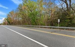5 acres for development. Zoned residential and commercial, but check it with the County. All buyers visiting the property must be accompanied by a Realtor. Anyone entering the property or the existing house will do so at their own risk and will hold Seller and Listing Broker harmless. Property being sold as is. Information is not guaranteed, do your own due diligence.