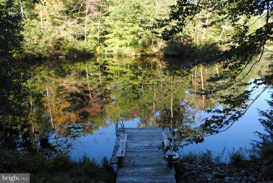 Beautiful Maintained Lake Front Property tucked away for privacy in a quiet setting.  Spacious open floor plan w/ vaulted ceilings, newly renovated kitchen with new floors through out.  Family room complete with fireplace and wet bar plus 2 car garage.  Enjoy your evenings relaxing on one of the 2 level decks over looking the lake. Professionally landscaped and walkway to pier.