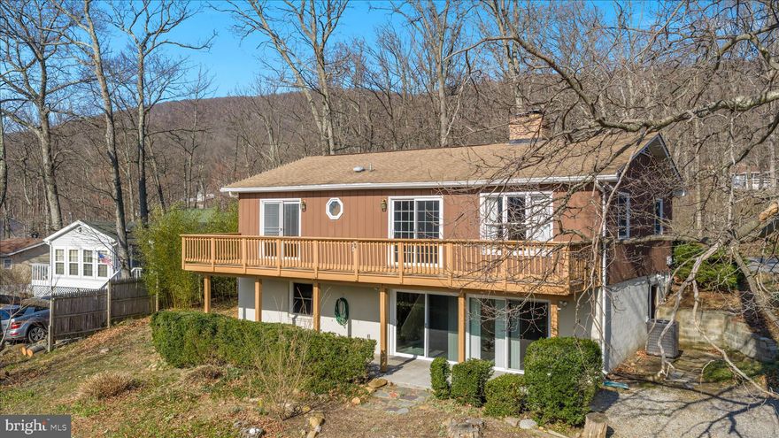 **NEW ROOF TO BE INSTALLED PRIOR TO CLOSING**

Second chance to own this home!!! Welcome home to this spacious 4-bedroom, 2.5-bath ranch nestled on two wooded lots in  Shawneeland - which has a lake, playground, beach and more! Situated on over half an acre, this property offers privacy, beautiful natural surroundings, and an abundance of flowers and mature plantings that create a peaceful setting.

Inside, you'll find finished living space on both levels, offering flexibility and room to spread out. The main level features two bedrooms, including the primary bedroom, while two additional bedrooms are located on the fully finished lower level. With multiple living areas including a family room and a recreation room, there is plenty of space for entertaining, relaxing, or working from home.

The kitchen offers ample cabinetry and updated appliances, making meal preparation easy and enjoyable. Cozy up to one of the two fireplaces, perfect for cooler evenings.

Step outside to enjoy the expansive deck that spans across both the primary bedroom and family room, ideal for morning coffee or evening gatherings overlooking the wooded surroundings.

The lower level features large sliding doors that allow for abundant natural light, creating bright and inviting living space with convenient ground-level access.

Additional highlights include a large carport and a spacious shed with electricity, providing excellent storage and workspace options.

Conveniently located just 10 minutes from Walmart and 15 minutes to downtown Winchester, this home offers the perfect balance of peaceful living with easy access to shopping, dining, and amenities.

Perfect for a first-time buyer or anyone looking for space, comfort, and a beautiful natural setting.

Welcome home!