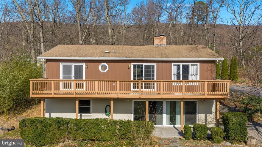 Welcome home to this spacious 4-bedroom, 2.5-bath ranch nestled on two wooded lots in  Shawneeland - which has a lake, playground, beach and more! Situated on over half an acre, this property offers privacy, beautiful natural surroundings, and an abundance of flowers and mature plantings that create a peaceful setting.

Inside, you'll find finished living space on both levels, offering flexibility and room to spread out. The main level features two bedrooms, including the primary bedroom, while two additional bedrooms are located on the fully finished lower level. With multiple living areas including a family room and a recreation room, there is plenty of space for entertaining, relaxing, or working from home.

The kitchen offers ample cabinetry and updated appliances, making meal preparation easy and enjoyable. Cozy up to one of the two fireplaces, perfect for cooler evenings.

Step outside to enjoy the expansive deck that spans across both the primary bedroom and family room, ideal for morning coffee or evening gatherings overlooking the wooded surroundings.

The lower level features large sliding doors that allow for abundant natural light, creating bright and inviting living space with convenient ground-level access.

Additional highlights include a large carport and a spacious shed with electricity, providing excellent storage and workspace options.

Conveniently located just 10 minutes from Walmart and 15 minutes to downtown Winchester, this home offers the perfect balance of peaceful living with easy access to shopping, dining, and amenities.

Perfect for a first-time buyer or anyone looking for space, comfort, and a beautiful natural setting.

Welcome home!