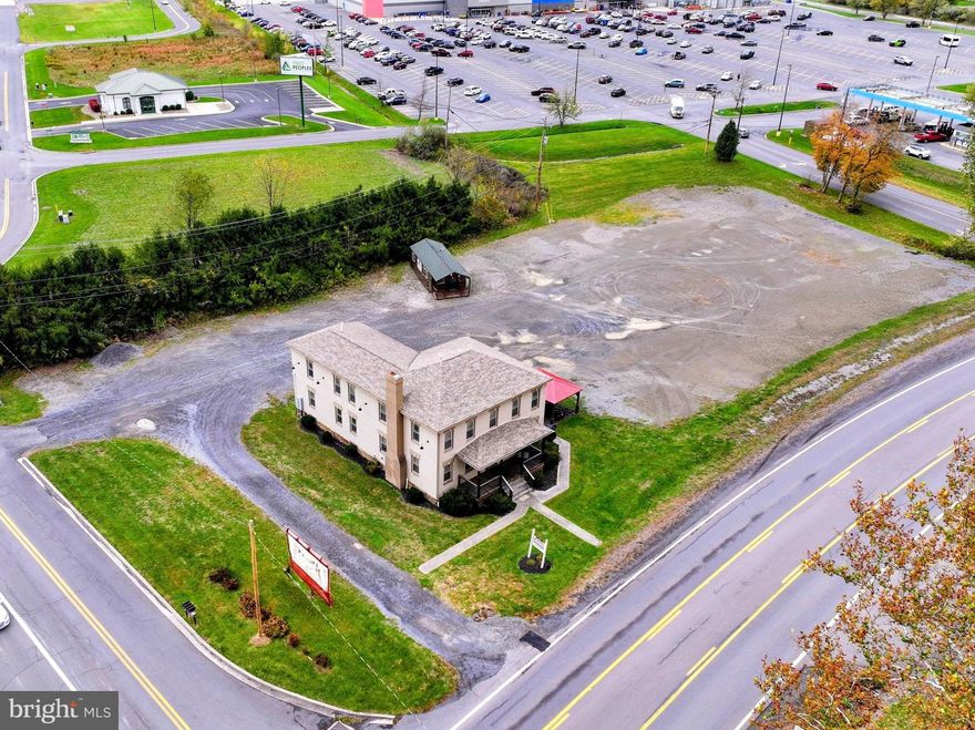 Outstanding investment opportunity along Route 93 / New Creek Highway — right next to the Walmart Supercenter! This property features a 4-unit apartment building situated on 1.5 acres of level land with excellent road frontage and visibility. Currently producing steady rental income, the site also holds exceptional commercial or business development potential thanks to its high-traffic location, two off-street entrances to the property, and direct access to one of the area's busiest corridors. Whether you're looking to expand your rental portfolio, develop retail or office space, or establish a new business, this property offers the perfect blend of income, location, and future growth potential. Utilities on site. Strong visibility, easy access, and endless possibilities.