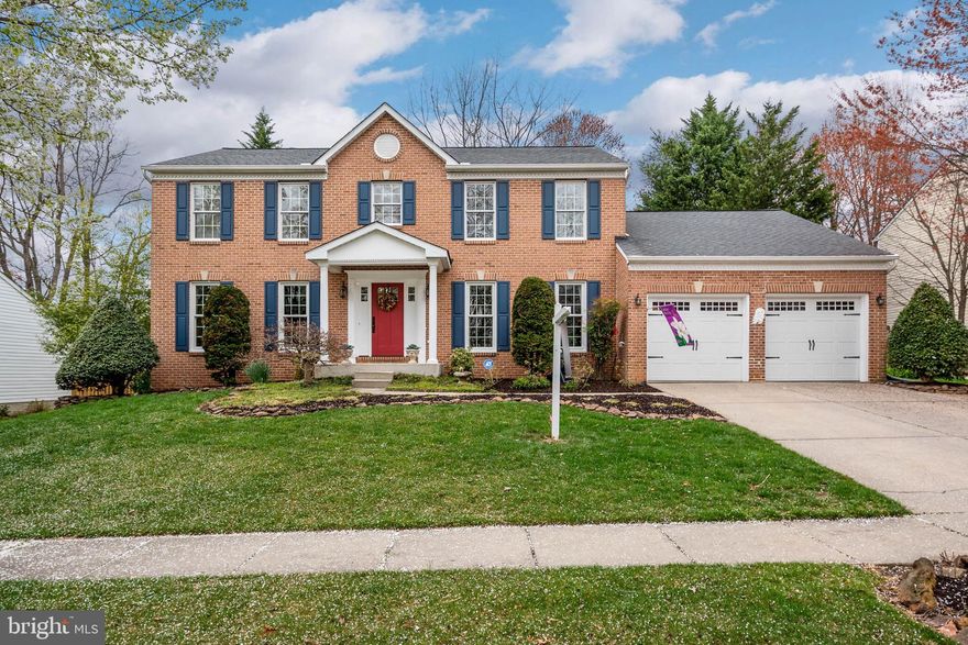This four bedroom brick front colonial shows like a model.  The home features hard wood floors, a formal dining room and living room (currently used as an office) with crown molding and chair rail.  The large eat in kitchen has an island, granite counter tops and tile back splash.  It opens to cozy bright family room with a gas fireplace and french doors leading to the deck.  The master bedroom suite has multiple closets, updated bathroom with a granite counter, a soaking tub, and separate shower with seamless glass shower doors.  The 3 other upstairs bedrooms are good sized with new carpet and are painted with neutral colors.  The basement is finished with large rec room, theater room, and large storage area.   The fenced yard is professionally landscaped with deck, patio, walkways, and is flat and open.   It also has a whole house attic fan.  The home has the following updates: roof (2009),  HVAC (2009), hot water heater (2015) and sump pump (2015).  This home is ready for its new owner.