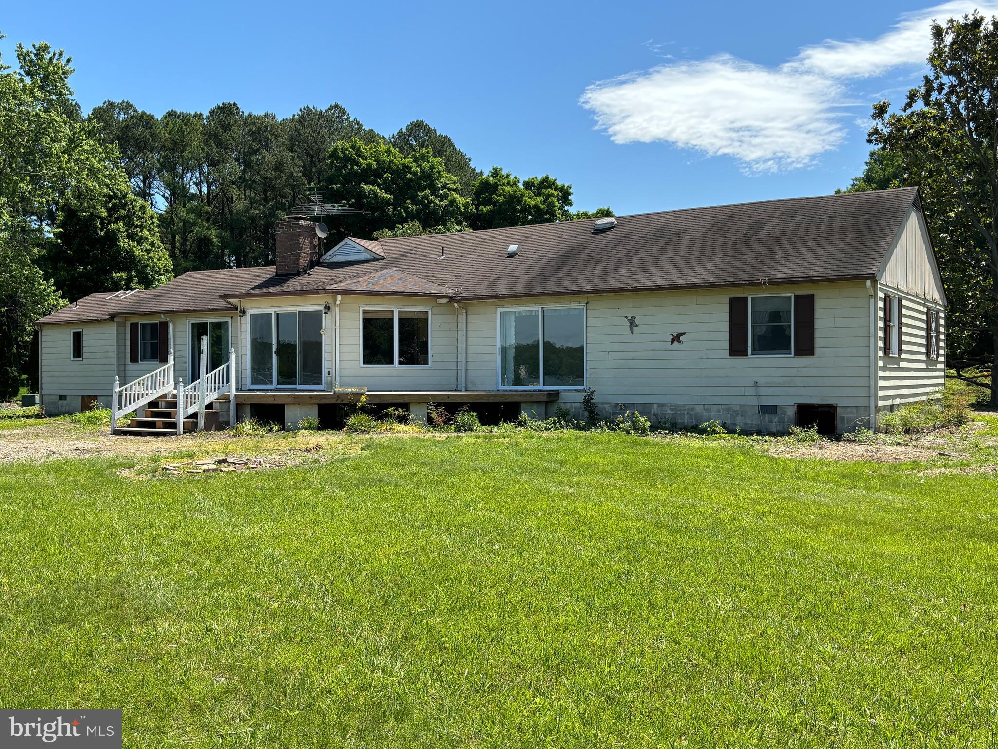 Top location off Bailey's Neck, Road about three miles from Easton and seven miles from Oxford. Fabulous water views. Year-round sunsets. Setback line shown on old plat was changed to accommodate existing residence; new plat included in documents. Do not go out on the existing dock; danger of falling through. Permit pending for replacement of dock. Cove is kept dredged to 3 to 4 ft MLW. Dredged depth continues to dock. Buyer may test depth to Buyer's satisfaction. Shoreline is fully rip-rapped.
Seller had the well capped off and had Delmarva disconnect the electric service.
By deeded covenant no short-term rentals are allowed at Peachblossom Point.
House needs major renovation but was well built in 1977. Needs new kitchen, bathrooms, flooring, probably remove the wall between kitchen and family room. But the house has an excellent floorplan. All carpet has been removed. High land, sandy soil. 2024 perk for 5 bedrooms HAS BEEN APPROVED by TCDeptEH.. All appliances are included but offered in AS IS CONDITION, probably not working. Seller is tagging some heirloom shrubs that are excluded from the sale, to be moved in the Fall.