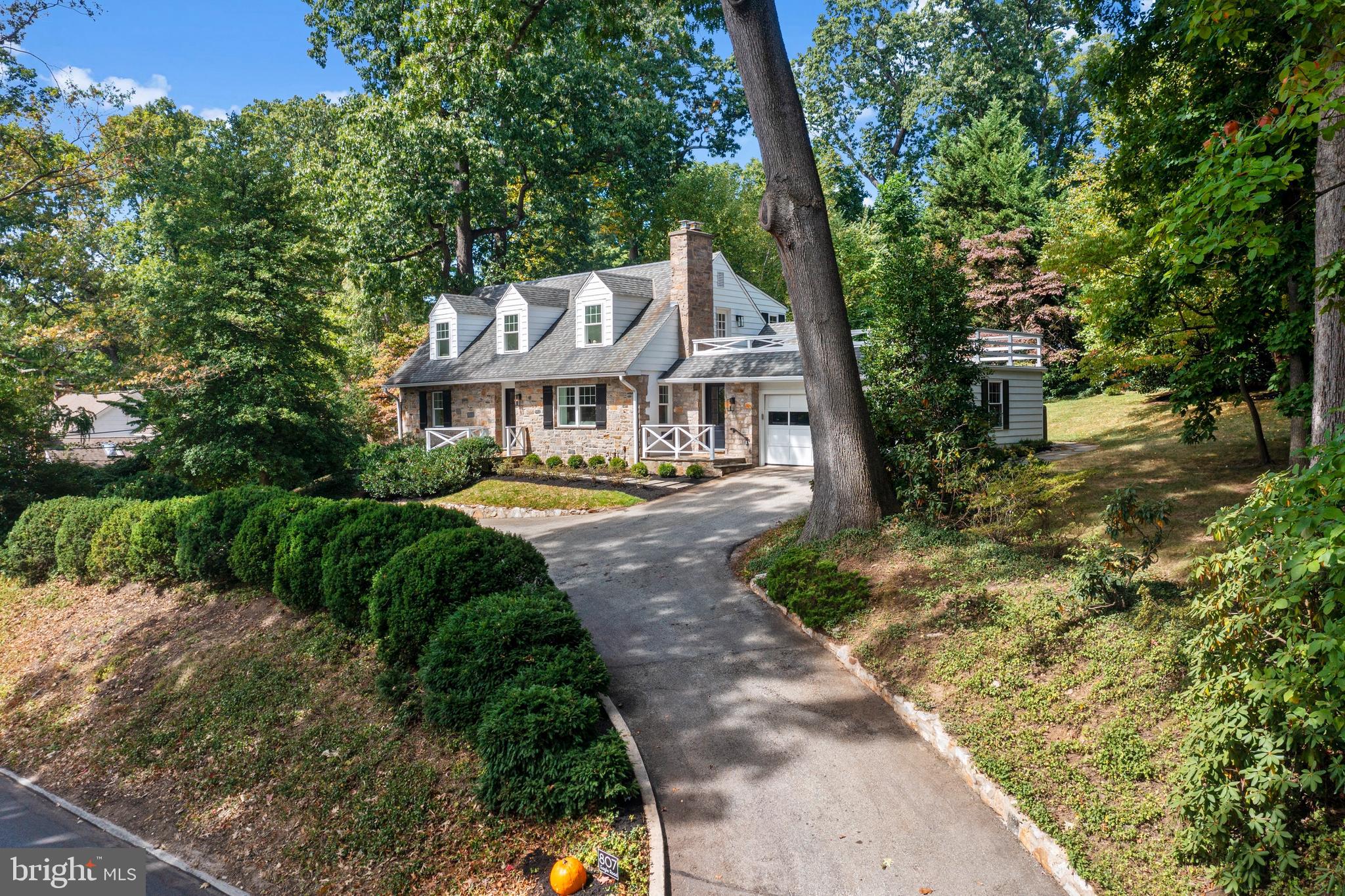 Thoughtfully redesigned, and renovated, 807 Eagle Rd is situated in the highly desirable and walkable N. Wayne neighborhood and located in the coveted Radnor School District.
This 4-bedroom, 3 full and 2 half-bathroom home offers over 2,600 sq ft of beautifully updated living space on a .51-acre lot. The extensive renovations include current design, while maintaining the classic features of this charming Cape Cod, with elements such as timeless stonework, flagstone entrances, original wood floors, deep window sills and solid wood doors. The exterior showcases lush landscaping and a spacious level yard.
The exterior renovations have transformed the home’s curb appeal with fresh and elegant upgrades. Highlights include decorative white porch railings in an X-style, new Therma Tru doors finished in black with gold hardware, all-new windows, freshly painted shutters and garage door, and a flagstone walkway. The landscaping has been refreshed, and new exterior lighting adds sophistication to the front and driveway, which offers parking for 4, in addition to the attached 2 car garage. Easy additional parking on Chestnut Ln across the street.
Inside, the home has been completely opened up for today’s lifestyle. The entryway is welcoming with natural light coming through the front door windows. To the right, the main floor was reconfigured into a gorgeous open floor plan, and painted in a classic tone that enhances the sense of space. The living room features refinished oak hardwood floors, wood-burning fireplace with painted brick surround and mantel, built-in bookshelf, and all new windows and trim, as found throughout. This room opens to the gourmet kitchen designed with sand-colored cabinetry with gold hardware, white quartz countertops with delicate veining, a large center island that seats four, and subway tile backsplash. Professional-grade appliances include a 6-burner stove, microwave drawer, and a wine/beverage fridge. The breakfast room features a custom upholstered banquette that can seat 10 - 12, with a striking chandelier that serves as a statement piece. The entire home features all-new designer lighting, adding elegance to every room. The kitchen opens onto a patio and private backyard. The mudroom includes a 5-foot pantry wall, custom built-in bench with storage, and two entrances, including one to the garage.
To the left of the main entrance there is a front room that can be used as a quiet office, or den and has an attached new powder room w/ custom cabinetry and thick countertop. A guest suite (bedroom #4) at the rear of the home includes a private ensuite bathroom w/ marble countertops and a walk-in shower.
On the second floor, the primary bedroom suite is a serene retreat with windows that overlook the treetops of Wayne. Included are a walk-in closet, built-in vanity/desk, and newly added ensuite bathroom, featuring a fluted vanity with double sinks, and spacious tiled shower. Bedrooms 2 and 3 have been redesigned, with one offering a built-in desk/vanity, and walk-in closet. The hall bathroom showcases penny tile flooring and a mirrored medicine cabinet. The laundry area features a new stacked LG washer and dryer, along w/ built-in shelving.
The lower level of the home offers 501 sq ft of flexible living space. Freshly painted with new carpet, this area includes high ceilings and can be used as a playroom, exercise bonus room. The second powder room, fully renovated, is located on this level, as are storage rooms and a utility room. A walk-out entrance provides access to the side yard. The home also includes a Generac whole-home generator.
This move-in ready home effortlessly blends timeless charm with modern convenience. Its prime location allows you to walk via sidewalks to some of Wayne's best destinations, including the vibrant restaurants and boutiques of downtown Wayne and the Wayne Train Station. Eagle Village Shops and Stafford Farmers Market are less than a mile away. This home has it all!