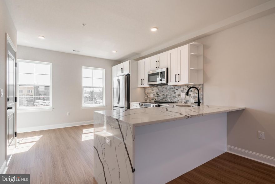 Welcome to your dream home nestled in the elite community of  Wynnefield Heights Square, introducing a beautiful new construction condo at 4082 Conshohocken Avenue A16,  Philadelphia PA. This chic residence boasts 3 spacious bedrooms and 2 modern bathrooms, all enveloped in the comfort of an energy-efficient HVAC system. 
Step inside to find a meticulously crafted interior, featuring Quartz countertops that add an elegant touch to the sleek kitchen. Stainless steel appliances and high wall cabinets underscore the kitchen's modernity, while under-cabinet lighting brings warmth and functionality to your cooking space. The living areas boast beautiful white oak engineered flooring, creating a seamless flow throughout the home. 

Natural light floods the space, highlighting the thoughtful details like wood baseboard molding and the cozy patio off the dining room - a serene spot for your morning coffee or evening relaxation. The chic exterior combines brick and vinyl siding, enhancing the building's charm and curb appeal.  Awaiting approval, benefit from a 10-year tax abatement that promises affordability. 

Assigned outdoor parking is available for $30,000, ensuring your vehicle's security just steps from your door for an additional fee. Embrace the future of living, available October,  2025. Your oasis in Wynnefield Heights Square awaits.