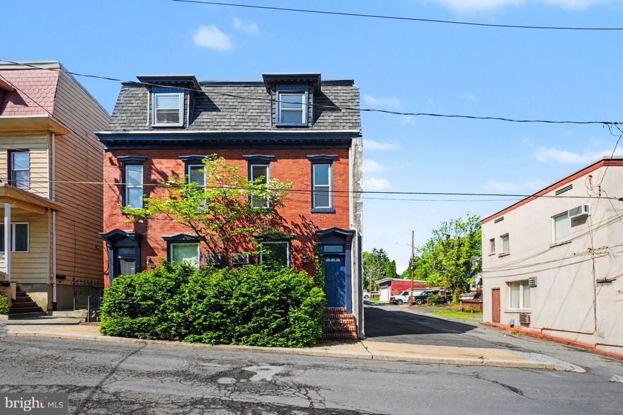 Welcome to this beautifully maintained and exceptionally spacious home in the heart of Pottsville — offering the perfect combination of charm, functionality, and flexible living space. With 5 bedrooms, 2.5 bathrooms, multiple bonus areas, and private off-street parking for up to 8 vehicles, this property is ideal for growing households, multi-generational living, or anyone seeking extra space to live and work comfortably.

From the moment you arrive, you’ll appreciate the inviting curb appeal featuring a beautiful flowering dogwood tree, mature maple trees, evergreen landscaping, and peaceful patio garden areas that create a warm and welcoming setting.

Inside, the home offers a thoughtfully designed layout filled with character and versatility. The main level features a spacious living room, formal dining room, convenient half bathroom, bright patio room, and a flexible office or bonus space with its own private entrance — perfect for a home office, guest suite, playroom, or additional bedroom.

The second floor offers a comfortable and inviting primary bedroom complete with large windows, recessed lighting, and generous his-and-hers closets. An additional bedroom and a full bathroom are also located on this level, along with a beautifully designed eat-in kitchen featuring Wilsonart Thinscape countertops, tile backsplash, Kraus porcelain undermount sink, Moen gooseneck faucet with spray attachment, garbage disposal, dishwasher, and electric stove. Just outside the kitchen, enjoy a private second-floor deck — the perfect place for morning coffee or evening relaxation.

The third floor provides two additional spacious bedrooms, another full bathroom, and an oversized walk-in storage closet, offering plenty of room for storage and organization.

Additional highlights include:

* 2 full tile bathrooms with quality Moen and Delta fixtures along with American Standard toilets
* Large basement with approximately 500 square feet of storage space
* Laundry area with washer/dryer hookups, laundry tub, and folding station
* Efficient EFM oil furnace and 40-gallon Rheem electric water heater
* Classic radiator and cast-iron baseboard heating system
* Attached side parking lot accommodating up to 8 vehicles — a rare and valuable feature

Conveniently located near local schools, parks, shopping, and everyday amenities, this unique property offers space, flexibility, and comfort both inside and out.

Don’t miss the opportunity to make this exceptional Pottsville property your next home. Schedule your private showing today!