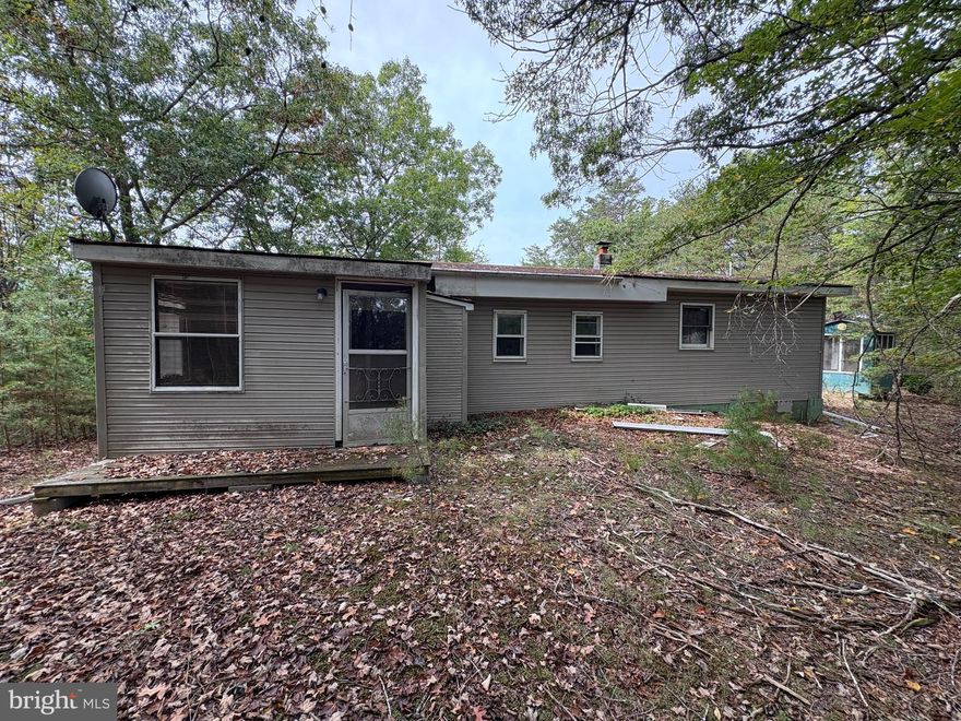 Every project starts with potential—and this one begins on 5.66 acres of fully wooded ground, shaded by mature hardwoods and tucked away for total seclusion. Whether you envision a hunting retreat, a rental investment, or a home brought back to life, the setting makes the effort worthwhile. Wildlife is abundant, privacy is assured, and yet you’re only minutes from Moorefield, WV, just off South Fork Road, where you can enjoy both the river and the mountains. The house itself is ready for someone with vision. It offers two bedrooms, a full kitchen, full bath, office, living room, and dining room. Flooring is a mix of vinyl and carpet, with both drywall and wood-panel walls throughout. Heat is supplied by portable electric baseboard units, along with a pellet stove in the dining room for added comfort. Utilities include public water, a septic system, and an electric hot water tank. Two outbuildings provide room for storage or workshop space, and a covered front porch gives the home a classic country touch. While the house requires significant renovation, the combination of land, location, and opportunity makes this an attractive option for investors, flippers, or anyone looking for a private spot in the mountains of West Virginia. Strictly sold as-is, this property is waiting for the right buyer to unlock its full potential.