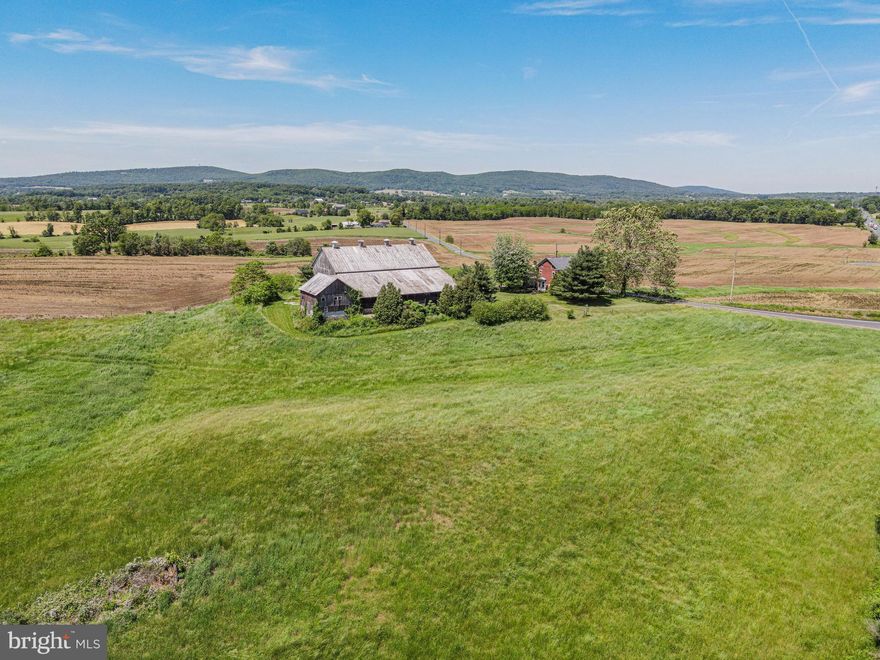 Welcome to your own piece of paradise with stunning views of Pennsylvania's Blue Ridge Mountains! This remarkable property is not preserved and boasts 128 acres of sprawling beauty. Route 15 splits the 128 acres with approximately 28 acres on the east side and 100 acres on the west side. There is substantial truck access to the east and west sides from Route 15. The property is 58 miles from the outer loop (Route 695) of Baltimore MD and 52 miles from Frederick MD. With approximately 115 acres of tillable land, enjoy sweeping views of the mountain range from the 4-bedroom, 2-bathroom brick farmhouse. The property also features an impressive wooden bank barn with a spacious overhang, perfect for agricultural use, storing equipment or hosting memorable gatherings. You're just minutes away from the charming town of York Springs, 20 minutes to historic Gettysburg, and 30 minutes to Harrisburg, ensuring a perfect blend of rural tranquility and urban convenience. Don't miss this opportunity to own a piece of Pennsylvania's picturesque countryside!