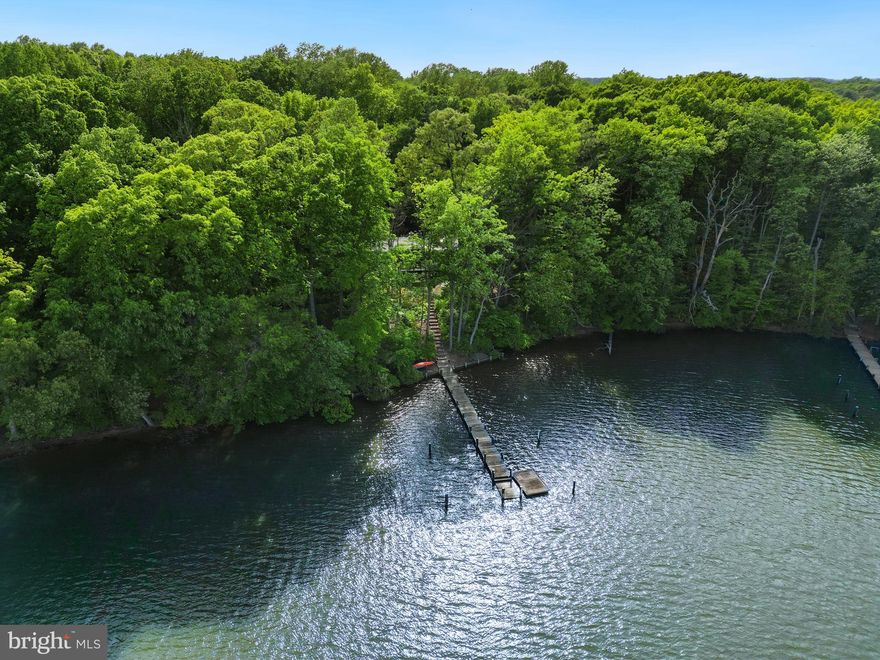 Welcome home to Creek's Edge at 6577 Elizabeths Lane – a beautiful, light-filled Deck House set on 5 acres with deep water on Shipyard Cove. With numerous recent updates, glass walls with incredible views, 5’ MLW, a tennis/pickle court and close proximity to both Rock Hall and Chestertown, this is the getaway that you have been waiting for. As you turn off of Martin Wagner onto Elizabeths Lane, slow down, take a breath, and relax…the community is an incredible retreat full of flora and fauna, and also a strong sense of neighborhood. As stated on their website, “warm wood, open floor plans, walls of glass, and soaring ceilings are the signature elements” of a Deck House, and this one does not disappoint. Waterfront and woodland views are present in every room through the expansive glass windows. Pull under the MCM-styled carport and enter the front door. Upstairs is an open plan and amazing panorama of Shipyard Creek. To the left is the living space, including an enormous living room with double sets of sliders to the new modern deck. At the center of the room is a raised hearth fireplace. Open to the living room is the dining room with banquette seating with bonus storage, and sliders to the outdoors. Open to the dining room is the updated kitchen with island seating and abundant storage, as well as amazing counter space for meal prep. Nearby is the screened porch with a ceiling fan, overlooking the circular firepit seating area on the waterfront. On the other side of the kitchen and living room, pass through pocket doors to an area that could serve as a primary suite, or is currently used as a primary bedroom with amazing water views, a guest bedroom, and a full bath. Downstairs is an expansive family room with new LVP flooring and a direct walk-out outdoor access. To the left of the family room is one bedroom. To the right, are two more bedrooms. Down the hall is a storage area under the stairs, a full hall bath, and a laundry room with storage and utilities. An easy drive to Philadelphia, Annapolis, Wilmington or Washington DC, and equipped with high speed internet, this home can easily be a full time residence, or a weekend getaway.