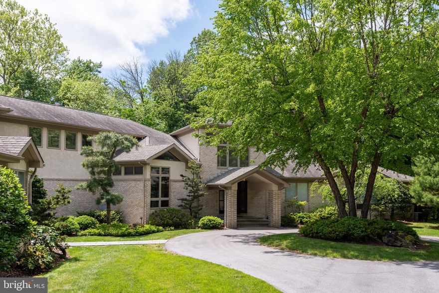 This gem of a house, inspired by Frank Lloyd Wright, was custom built by the sellers and is on the market for the very first time! Nestled on 1.8 acres with breathtaking waterfront views of the Springton Reservoir, this 5 bedroom 3.2 bath home seamlessly blends natural elements with meticulous craftsmanship. (Public records is incorrect - house has 5 bedrooms and square foot is 7,305 per architectural plans. The septic system was built for a 5 BR home, not 4 and the 5th bedroom’s closet was removed and can easily be restored.) Enter the elegant view-through foyer with custom shelving and a planter box equipped with a fountain. Throughout most of the house there is radiant floor heat and solid wood mahogany doors & trim. The main level has hardwood floors, built-ins in many rooms, stained glass windows which all set the tone for elegance and sophistication. This home boasts a thoughtfully designed floor plan featuring a private wing on the main level. This wing includes a luxurious bedroom suite with entry via French Doors to a large room with gas fireplace, built-ins, baths, walk-in closets and private dressing room for her with floor to ceiling mirrors. All the primary suite baths have supplemental electric coil heat in the flooring. The large bathroom boasts a jacuzzi tub, stall shower, vanity and views of Mother Nature. Also in this wing, is the laundry room with sink & sewing station and an office/library ideal for remote work or quiet reflection.Entertain in style in the dining room adorned with stained glass, hardwood floors while the adjacent living room offers a panoramic wall of windows framing picturesque views of the lake and surrounding trees. Enjoy the living room built-ins for storage, the slate surround gas fireplace, motorized blinds and egress to the back deck. This deck is crafted from IPE an exotic Brazilian wood renowned for its durability & low maintenance.The gourmet kitchen is equipped with top of the line appliances including a Thermador 4-burner gas stove, Sub-Zero refrigerator, Miele dishwasher, Bosch double wall-oven and a Bosch Microwave. The island boasts a soapstone top, wine cooler and lots of storage cabinetry. The other countertops are granite with tile back-splash. Ample storage is provided by 2 spacious pantries while a built-in desk and file drawers offer convenience for personal paperwork. Adjacent to the kitchen is an inviting office space with beautiful built-ins and a tray ceiling. This room opens to a sun drenched 4-season sunroom overlooking the lake. This room is tiled, has radiant floor heat, sliding wall systems. If one prefers, just use the screens or open the doors leading to the deck.The carpeted second level offers 4 additional bedrooms, two full baths and a laundry closet. Two bedrooms open to private balconies with lake views. The closets in each bedroom are custom built and there is a linen closet in the hallway.The finished lower level is fabulous- complete with radiant floor heating, a powder room, a pool table which stays and tons of storage space. A gym provides the perfect space for staying active and there is egress to the backyard from the main area which all offers seamless indoor-outdoor living.Additional features of the house include a re-circulating line for hot water for all faucets, an oversized 3-car garage with abundant storage and the roof features 50 year architectural shingles. When building, the owners thought of everything including an option for an elevator. Therefore, there are closets on ALL 3 levels should one wish to install an elevator.Welcome to this amazing home of unparalleled beauty where every detail has been thoughtfully curated to elevate the art of living.   Conveniently located to private schools & major highways. NOTE: Video cameras are active, Audio is not. Sellers prefer late summer closing.