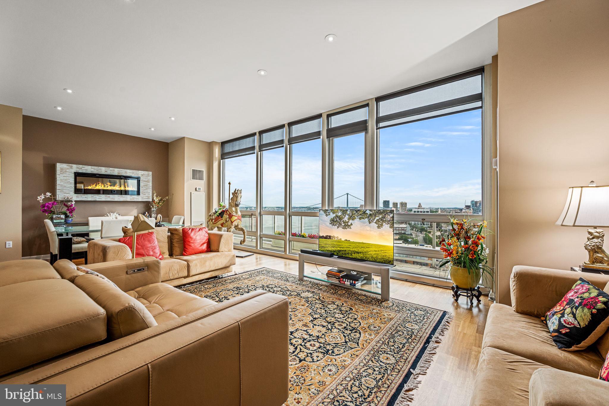 Unobstructed East-to-West Skyline Views;
Perched on a high floor in the exclusive Reef building at Waterfront Square, Residence F2003 offers a rare opportunity to experience Philadelphia living from an unmatched vantage point. Unobstructed views stretch from the Delaware River bridges, across the entire Center City skyline, and westward to the sunsets! Every glance is framed by floor-to-ceiling windows and a full-length private balcony.
This elegant, penthouse-style residence includes two dedicated garage parking spaces and an open-concept layout designed for both everyday living and entertaining. The redesigned chef’s kitchen showcases a generous island oriented toward the skyline, custom cabinetry, granite countertops, and stainless steel appliances. Two spacious bedrooms are thoughtfully placed on opposite sides of the home, each with balcony access, ensuite bathrooms, and custom closets. A large enclosed den, easily convertible into a third bedroom, office, storage, or media room adds flexibility.
Recent upgrades include hardwood floors throughout, a wall-mounted fireplace, Murphy bed in the second bedroom, renovated bathrooms, designer sunshades with lightly tinted windows, and a reimagined laundry room with custom storage.
Waterfront Square is a prestigious, gated community offering resort-style amenities:
24/7 concierge and security
Fitness center with steam, sauna, and massage rooms
Heated indoor pool and hot tub with expansive sundeck
Philadelphia’s largest green roof and landscaped grounds
Garage parking with EV charging stations
Complimentary weekday shuttle service to local stops and 30th Street Station, with direct Amtrak connections to New York City and Washington, D.C.
All just minutes from Center City, major highways, and Philadelphia International Airport.
Experience the ultimate blend of luxury, convenience, and iconic skyline views—schedule your private showing today.