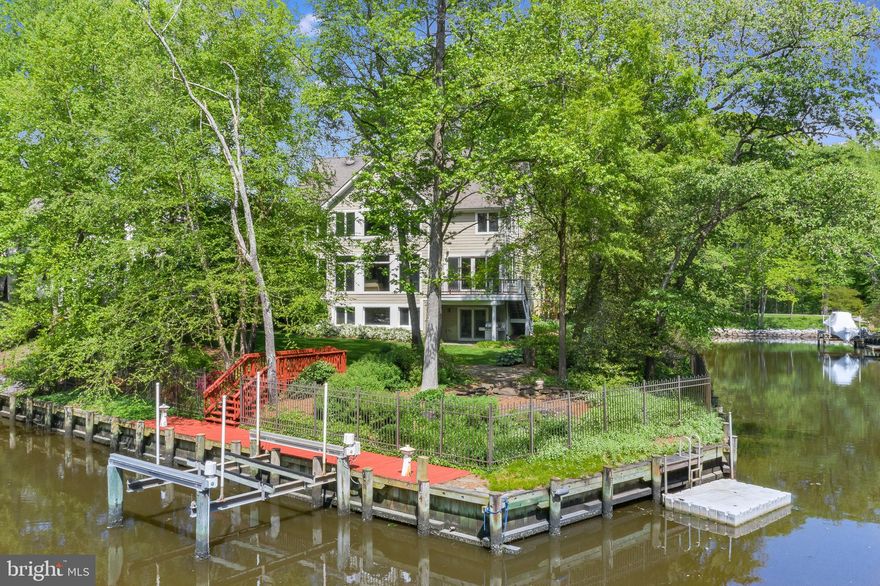 Spacious, private waterfront  home  located on cul de sac flag lot  features 5 Bedrooms, 4 Full & 1 half baths. Private pier with 3 feet MLW on Homewood Canal off of Whitehall Creek with new 6000 lb lift  and floating dock for your kayaks. Waterside 8 person hot tub (2018),  flagstone fire pit area, room for lacrosse nets all enclosed by an aluminum fence  Comfortable and inviting interior, with open concept living, walls of windows and natural light, 9 ft coffered ceilings, hardwood floors, gas fireplace & waterside balcony. Spacious gourmet kitchen with large granite island, stainless steel appliances and huge pantry.  The main level also includes a beautiful dining room & professional office w/ a set of french doors and water views. Fabulous master BR features bath w/ separate soaking tub , double walk-in closet, and expansive water views.  Fully finished walk-out lower level includes 5th bedroom, high ceilings, new carpet, and  ample entertaining space including a performing stage & cedar closet.  This home comes with an oversized 3-car attached garage with additional driveway parking.  Quick/easy access to RT 50, the Chesapeake Bay Bridge and historic, downtown Annapolis.
