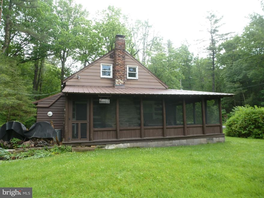 This cozy log cottage/cabin has vaulted ceilings, exposed log walls and wood floors throughout. Great room with fireplace. Kitchen/dining area with wood floor. One bedroom and full bath. Heat/cooling split system. Loft for additional use. Screened in porch to sit and enjoy the great outdoors. Convenient location to state parks, Appalachian Trail for hiking, mountain bike trails, fishing, lakes and easy access to major highways. CASH only sale and must be a PA resident. State Forest Campsite Land Lease $200 / year. Call today for your private showing!