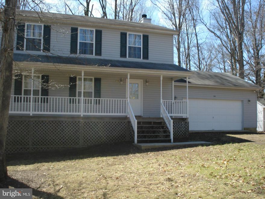 LOTS of room in this house! From the formal living room, dining room, family room with woodburning fireplace, 4 spacious bedrooms upstairs and a completely finished basement with it's own full bath!  For a total of 4 bedrooms, 3.5 baths.  Deck on the back overlooking the LEVEL back yard, covered front porch and oversized 2 car garage.  On paved road near lake beach.