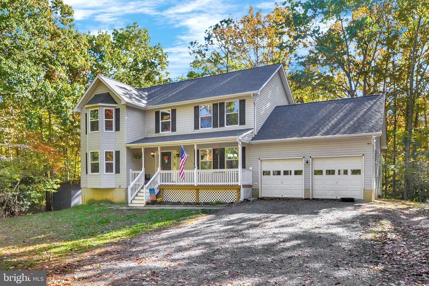 Privacy, Privacy, Privacy!  This home is nestled on 0.67 acres and offers 4 bedrooms, 2 full baths and 2 half baths.   Archways lead you through the main level.  Spacious family room has built-in bookshelves and bay window that provides wonderful views of the wooded lots.  Dining Room with hardwood flooring.  Country-style kitchen provides plenty of cabinetry, newer appliances, breakfast area, and pantry.   Primary bedroom with walk-in closet and bathroom.  Good-sized secondary bedrooms.  Unfinished basement provides area for indoor activities.  Large covered front porch and deck offers amazing outdoor living space.....perfect for nature lovers!  New architectural shingled roof added this year (2021).   Two-car garage is 20 ft. x 24 ft.  Large side-yard is perfect for outside activities and play area.  This property is located in close proximity to the Soundings Neighborhood, but is part of the Chesapeake Ranch Estates.  Schedule your showing today!