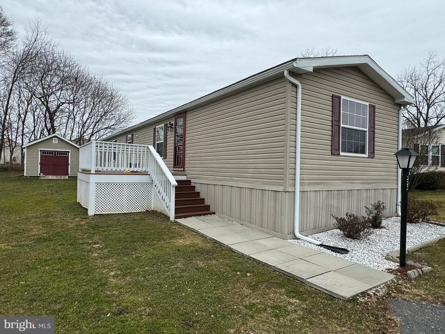 This well-maintained 16x68 REDMAN home was just inspected for resale. Own the propane tanks! The XL shed with electric is perfect for a man cave/workshop! Blinds and most furnishings are able to stay! Of course, appliances can stay: front loader washer/dryer, refrigerator, stove/oven, dishwasher, and built-in microwave. Has many upgrades like ceramic tile edged countertops, black kitchen sink, TREX decking, tilt-in vinyl windows, gutters. Master bath has a XL walk-in shower. Central air/furnace has been recently serviced.  New hot water heater 2019. Pet friendly all ages community in Lincoln Greens area of Ephrata. Walk to Main St, shopping, restaurants. $430 monthly lot rent. Optional 1 yr home warranty is available for purchase. See 31 pics!