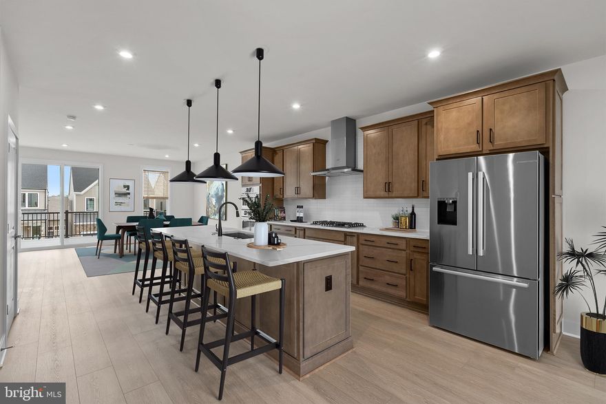 Brand new elevator style luxury Van Metre Townhouse with 3 bedrooms and 2.5 bathrooms in the Active Adults 55+ community of Lexington Square, ready for IMMEDIATE DELIVERY. The gorgeous great room with a designer kitchen includes dining space and a statement fireplace. It has access to a huge deck overlooking the open common space and backyard. The open concept gourmet kitchen features stainless steel appliances (including a 5 burner Bosh cooktop with chimney hood), a gigantic island, pantry with solid shelving, upgraded white backsplash, and incredible quartz countertops. This spacious main level also includes a study with a lovely window, perfect for every-day use, as well as an abundance of natural light throughout with beautiful, recessed lighting and 10’ ceilings that create plenty of room for life’s celebrations. The upper level has all 3 bright and spacious bedrooms. The primary bedroom steals the show with its vaulted ceilings, huge walk-in closet, recessed lighting, and a spa inspired bathroom. This primary bathroom includes dual vanities (soft close cabinets), more incredible quartz countertops, and an accessible/beautiful roll-in frameless shower (floor to ceiling tile and built-in seat). There’s more natural light throughout the 2 additional bedrooms which have stain resistant carpeting, walk-in closets, and plenty of space to relax. The second full bath is gorgeous and functional with a tub! The lower level has the main entrance and a massive rec room with walkout access to the private fenced backyard, excellent for entertainment. This is the perfect home for life’s milestones with several accessibility features, including a private elevator. There are also many sustainability features like an instant tankless water heater, structured home wiring system, and it’s ready for solar panels! Enjoy peace of mind with the builder’s post-closing warranty and move in today. This boutique community is designed with a smaller, close-knit feel to encourage meaningful relationships with neighbors. Enjoy thoughtfully curated amenities including walking trails to Lansdowne Woods, a pollinator garden close by a County preservation area, and active recreation areas. Every detail at Lexington Square has been designed to offer comfort and ease, creating the perfect backdrop for vibrant living. Perfectly situated just off Route 7, you are just moments away from One Loudoun, Belmont Chase Town Center, Lansdowne, and all the essential shopping and dining Ashburn offers. Also conveniently located close to the Metro’s Silver Line, Dulles International Airport, commuter routes, and health centers including Inova, making it a prime destination for those seeking a well-connected and vibrant lifestyle.
Take advantage of $15,000 for closing costs by choosing Intercoastal Mortgage and Walker Title.