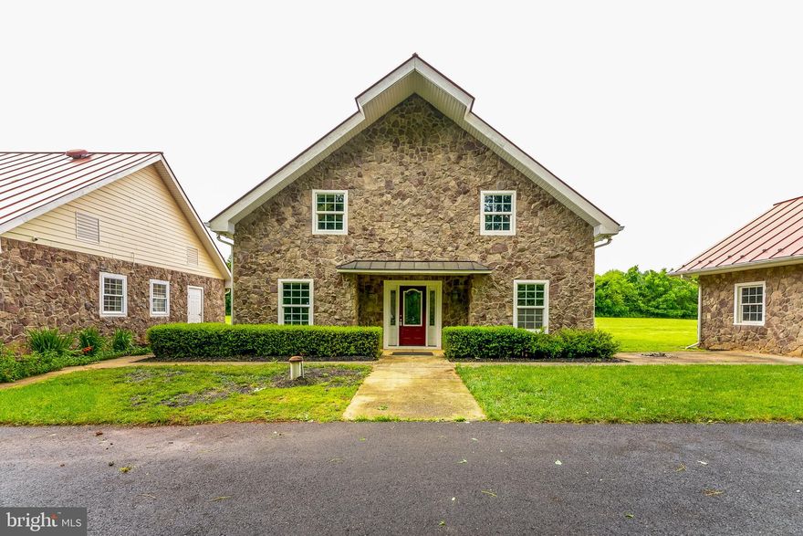 This property is a must see. There are 4 buildings including the house on 5 acres. The house has 3 bedrooms and 2 bathrooms, there is 2 bedrooms and a full bath on the main level with a kitchen and family room and laundry on this level. The upstairs has a full bath and a master bedroom suite. The first building has two bathrooms and large open area kitchen ( This was previously used for cleaning vegetables commercially) The third building houses the irrigation and also has a drive thru one bay garage. The fourth building has a oversized large drive-in garage with a greenhouse attached. This property is being sold as-is.