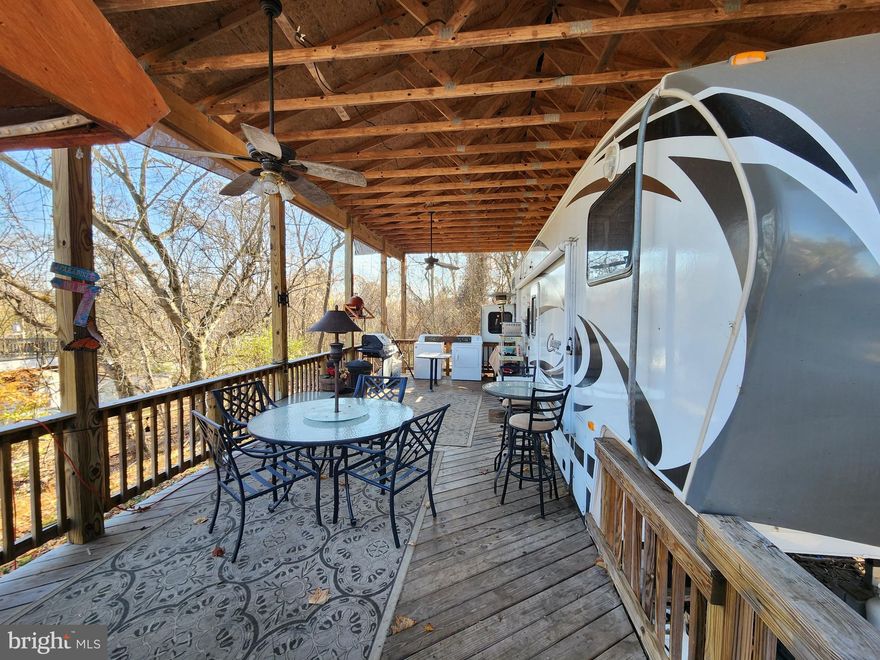 You cannot build this for this price! It's a DEAL 

Welcome to Block 89 Lot 10 Never glades in Riverbend Rv park, where you own your own property in a seasonal campground on the Potomac River full of amenities. Open April 1 - November 1. BRING AN OFFER

This lot has plenty of parking, yard space and backs to trees. No neighbors right on top of you. Extra-large pavilion and deck have ceiling fans, built in Tiki bar, washer - dryer, grill, tables, chairs and more. 
Everything you see conveys. 2012 Keystone Cougar 5th wheel camper has the primary bedroom with full bath and stand-up shower on the right end and a full-sized bedroom and half bath on the other end with a loft that holds a king-sized mattress. A good cleaning and some TLC and here you'll have your glamping paradise.
12 Miles of deep water on the Potomac River access for boating, fishing & swimming. Yearly membership includes water, sewer, electric, trash and the park amenities such as 3 pools, putt putt, basketball, tennis, fireworks, car show, restaurant, playground, ball field and much more. Bring your golf carts, water toys and come enjoy life! Yearly dues are $1,775 plus a $200 initiation fee for new owners. This includes water, electric. pump  outs and all the amenities.