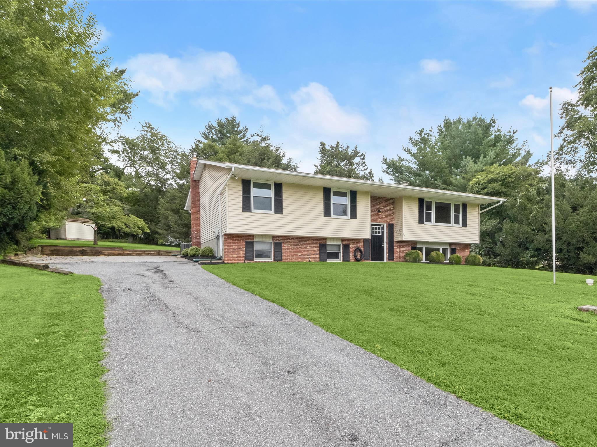 Welcome to this charming bi-level home in the Lakeland Heights community of Finksburg, MD, nestled on a spacious 0.74-acre lot offering comfort, functionality, and room to grow. With 1,476 sq. ft. of well-designed living space, this inviting residence features three bedrooms and two and a half bathrooms, blending traditional warmth with thoughtful updates. The open main level welcomes you with a sun-filled living room featuring a bay window, plush carpet, and a neutral color palette that flows effortlessly into the dining area. Enjoy elegant meals under updated lighting and luxury vinyl plank flooring. The kitchen is beautifully appointed with granite counters, soft-close cabinetry, a center island with a wood countertop, electric cooking, a pantry, and stainless steel appliances, perfect for both everyday living and entertaining. The spacious primary suite offers a peaceful retreat with recessed lighting, a walk-in closet, soft carpet, and a private en-suite bath with a walk-in shower and luxury vinyl plank flooring. Two additional bedrooms and a full hall bath complete the main level. Downstairs, the lower level features a large recreation room with modern LVP flooring, a cozy wood-burning fireplace with a brick surround and wood mantle, a powder room, and a convenient walk-out to the driveway and landscaped yard, ideal for hosting, playing, or relaxing outdoors. Built in 1977, this home presents the perfect canvas for your personal touch while offering modern comforts in a serene setting. Convenient access to I-70, I-695, and I-795 makes commuting a breeze. Don’t miss this opportunity to call this delightful property your next home!