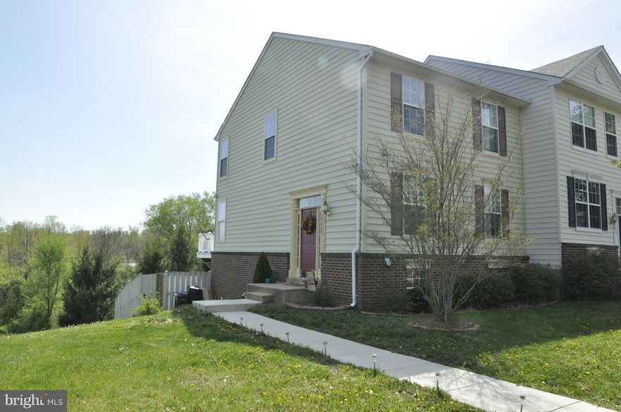 Gorgeous end unit in sought after Round Hill.  Eat In Kitchen with island walks out to deck.  Brand new carpet on main Level.  Fully finished basement walks out to fenced in backyard.  Possible Fourth Bedroom in Basement.  Lake Access, walking trails.  Two assigned parking spaces and visitor parking.