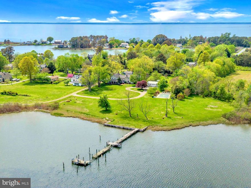 A storybook waterfront home with privacy, and timeless old-world charm. This Tilghman Island waterfront property carries a gracious, welcoming spirit: peaceful, and full of character. Large rooms, tall presence, mature trees, and a beautiful wraparound porch give the home a timeless, almost cinematic quality.

 Set down a long private driveway on Broad Cove, which connects to Harris Creek, this secluded 4-bedroom, 2.5-bath home offers 3,037 square feet of generous living space, 438+ feet of shoreline and a swimming pool.

Inside, the home offers expansive gathering spaces, including a large living room with a grand wood-burning fireplace, a spacious family room, a kitchen with a wood stove, and a generous primary bedroom with its own wood-burning fireplace. There is warmth and scale throughout. Old charm, big rooms, and the kind of relaxed elegance that is hard to recreate.  A dock is in place and in need of repair, offering the next owner the opportunity to restore and customize the waterfront experience.

Gracious, private, and full of soul, this rare Broad Cove property offers the presence and romance of a true dream home.
