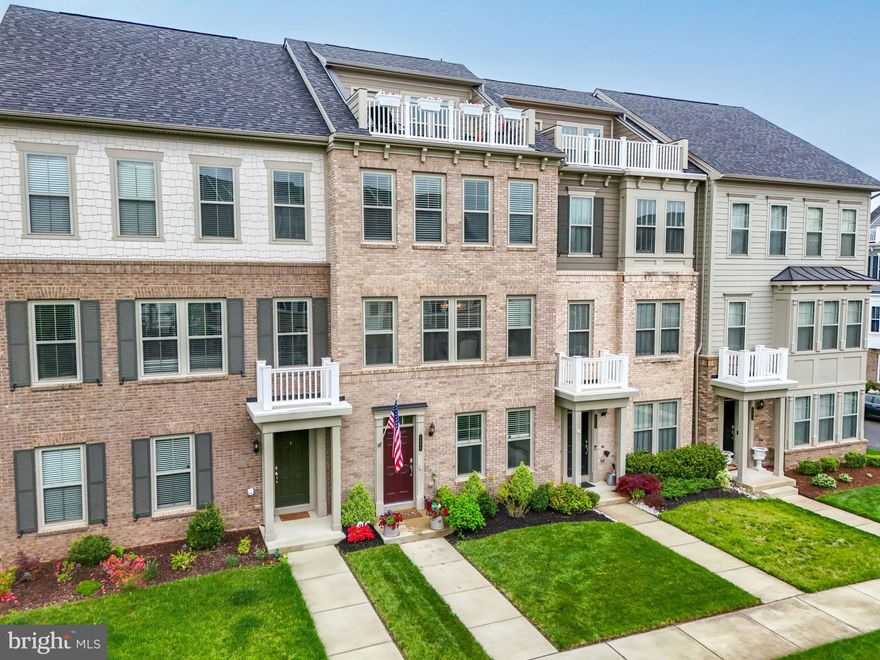 NEW PRICE for the best townhome value in Potomac Shores and also available for a VA ASSUMPTION: 3.5% interest rate. Please contact listing agent for remaining principle balance. Buyer would need to cover the difference and also have his/her own VA  eligibility. Located in the heart of the Town Center District, this 4-bedroom, 2.5-bath townhome features over $60,000 in thoughtful custom enhancements  and value-adding potential that truly set it apart from the others.  From the moment you arrive, the curb appeal is undeniable—manicured courtyard lawn, vibrant landscaping, and an inviting entry. Inside, you'll be greeted by HARDWOOD FLOORS THROUGHOUT the entire home, a rare and elevated touch that adds warmth and sophistication to every level. The entry-level flex space is currently styled as a designer home office, complete with custom built-ins and shelving. Whether used as a workspace, playroom, or guest suite, the possibilities are endless—especially with rough-in plumbing already in place to add a bathroom on this level, an upgrade that can significantly increase future value and versatility.  Continue on to the fully finished garage, a dream for any homeowner. It features epoxy-coated flooring, custom storage systems, wall-mounted organizers, and overhead racks, offering a pristine and functional space that’s often overlooked in townhome living.  Upstairs, the main level is designed for both comfort and entertaining. The gathering room features a custom gas fireplace flanked by custom built-in display centers, making a beautiful and functional focal point. Step outside onto your private deck, complete with a DEDICATED GAS LINE for grilling, ideal for morning coffee or sunset dinners. The chef-inspired kitchen is a standout, anchored by a large quartz-topped island with seating, surrounded by stainless steel appliances, five-burner gas cooktop, range hood, designer backsplash, and CUSTOM CABINETRY. Don’t miss the custom pantry with coffee station and broom closet and the built-in buffet, offering both elegance and ample storage. Adjacent to the kitchen is a cozy café-style dining nook and a stylish powder room, rounding out the main level’s welcoming and functional layout. On the third level, the primary suite offers luxury and retreat—featuring room for a king bed,  walk-in closet with custom organizers, and a spa-like bath with soaking tub, double sink vanity and a glass-enclosed shower. Two additional bedrooms with custom closets, a full bath, a linen closet, and a laundry area complete this level. The top-floor loft is the ULTIMATE BONUS SPACE—perfect for a media lounge, second home office, or "MAN CAVE" as it is now. From here, step out to your private rooftop terrace, an outdoor oasis offering courtyard views, a gas line for a fire table, and a hose bib for your rooftop garden or plant care. It's truly the ultimate space to relax, unwind, and entertain. All of this in the award-winning Potomac Shores community, where the $200/month HOA includes high-speed internet, trash service, and access to incredible resort-style amenities: three pools, the Shores Club Fitness Barn, 9+ miles of wooded trails, Tidewater Grill, and the Jack Nicklaus Signature Golf Course. Enjoy the canoe/kayak launch, community gardens, and a thriving calendar of social events. Families benefit from the nearby Ali Krieger Sports Complex, top-rated schools, and the exciting addition of the future VRE station and Town Center—all just moments away.