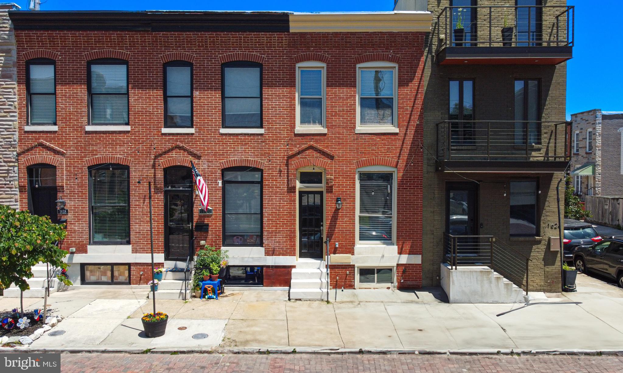Welcome to 1622 E Clement Street, a classic Federal-style rowhome nestled in the heart of Locust Point. This 2-bedroom, 2-bath home offers over 1,000 square feet of finished living space across two levels and showcases the perfect blend of historic charm and modern convenience.
The main level features a spacious living area with hardwood floors, a dedicated dining space, and a well-equipped kitchen with plenty of cabinet storage. A full bathroom on the main level adds convenience and flexibility. Upstairs, you’ll find two bright bedrooms and an additional full bath.
One of the home’s standout features is the rooftop deck, providing sweeping views of the surrounding cityscape—ideal for outdoor entertaining or simply relaxing above it all. A second deck adds additional space to enjoy the outdoors.
Additional highlights include central air conditioning, ceiling fans, a basement for storage, and classic brick construction. Located just blocks from neighborhood restaurants, parks, and waterfront paths, this home offers easy access to all that makes Locust Point a sought-after city neighborhood.
Don’t miss your chance to own a charming city residence with exceptional outdoor space in one of Baltimore’s most vibrant communities.
