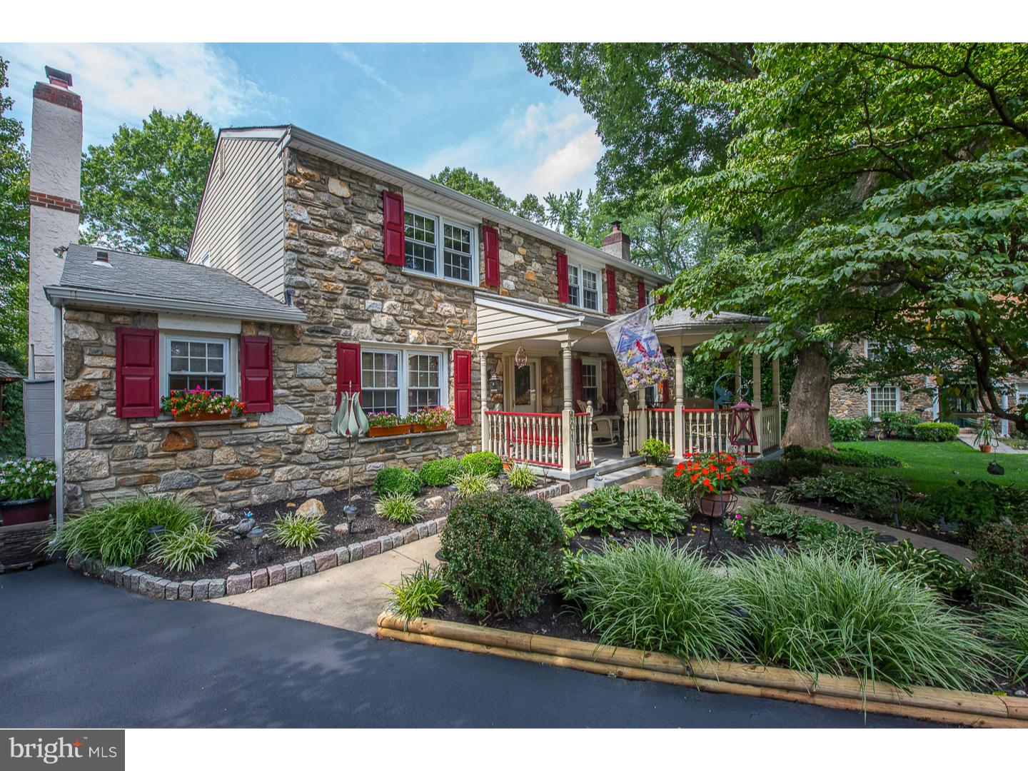 In an idyllic setting at the end of a cul-de-sac you'll find this spacious and lovely stone, colonial style home. This home is perfect for entertaining inside and out! Enter through a private, covered, gazebo like porch surrounded by beautiful landscaping and lush greenery. Main Level: Enter into the tiled Center Hall and notice the large Office or Study to the left and spacious Living Room to the right. Ahead is an updated eat-in Kitchen with granite countertops and abundant cabinetry that is adjacent to a nice sized Family Room with a gas fireplace set into an attractive stone wall. The main level includes a formal Dining Room as well as a beautifully designed Florida Room addition with abundant windows and a vaulted ceiling. The Florida room opens to a large deck, with an automatic awning, that overlooks the beautiful fenced-in pool area and the grounds beyond. This is the perfect "Staycation" Home! Completing this level is a spacious Laundry Room with loads of storage and a Powder Room. Second Level: Spacious Master Bedroom with two walk-in closets and ensuite bath with shower stall. There are three additional nicely sized bedrooms with a second full bath plus attic access via pull down stairs. Lower Level: Finished space with high ceilings plus a work bench and mechanical room. The grounds are completely private and rich with flowerbeds, blooming shrubs and trees. There are two sheds: one for gardening supplies and one for pool equipment. This property is situated in the highly rated Wallingford-Swarthmore School District and is close to major highways (476 and 95), the Philadelphia International Airport, the Media/Elwyn train to Center City, shopping centers and Media Boro.