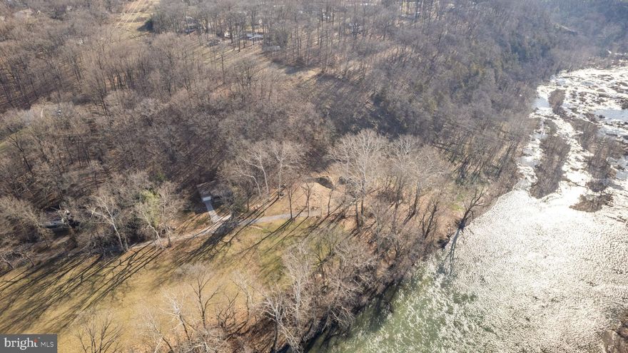 Offers, if any, will be reviewed Monday, 3/11 @ 5pm.  Once in a lifetime opportunity to create a dream home on the Shenandoah River.  This river front land in Harpers Ferry, WV consists of 2 lots totaling 0.81 acres on the final lot of a gravel road for quiet and privacy among the beautiful giant sycamores.  It delivers the perfect spot to put in for tubing, canoeing, kayaking etc. given it is just down river from a small hydroelectric dam.  This means you could use the river to get straight to Harpers Ferry Historical National Park.  Custom architectural plans have been finalized by DC/WV licensed architecture firm and approved by DC/WV licensed structural engineer.  The custom design evokes Scandinavian modern A-frame with the conceptual all black exterior intended to recede into nature like a shadow while creating a warm and inviting interior space.  Come build your own beautiful backdrop for your future memories and make it dual purpose by renting it on AirBnB (Jefferson County WV zoning permits short term rentals – see Zoning Ordinance Text Amendment File #ZTA21-01, buyer to verify).  The plans create two huge owner's suites on opposite wings of the house along with an office/den making this an excellent configuration for all your needs.  The main space is designed to provide soaring ceilings (26') with a wood burning stove and open kitchen / dining area with a screened in porch nearby to enjoy dining al fresco.  The front decks are huge and accommodate a separate landing area for a private hot tub.  The lower level would serve as a garage / huge storage or recreation room. The gravel road was extended via WVDOT approved plan, the site has been cleared and a brand new (75gal/minute!) Well by Negley's has been installed.  The septic permit is also in hand. Everything is squared away such that you could still make any final modifications to the architectural plans before final submission for permit.  Whether you're looking to create your dream home on the river or a 2nd home / vacation rental, this property and its design have you covered.  There's no HOA and high-speed Xfinity gigabit already serves the adjacent properties.
Please note that if you view the property, the red lines in the pictures help provide a rough approximation of the lot lines such that you can remain on the property when viewing.  Please note that the field is not part of the property and the property line starts at roughly the edge of the field, thank you!