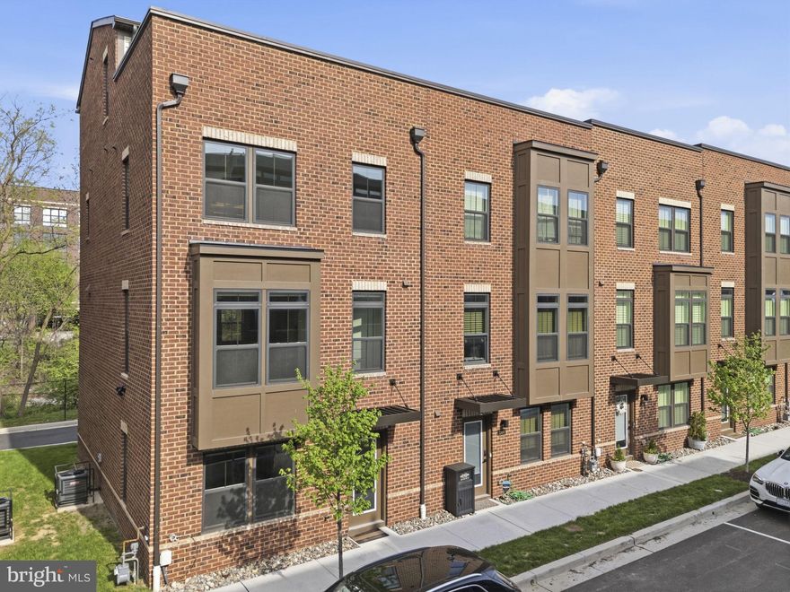 Welcome to Banner Row, Locust Point’s premier townhome community. If you’ve been searching for generous living space, effortless parking, and a prime location in the heart of Locust Point, this is the one.

Pull directly into your two-car garage, complete with EV charging, and enjoy convenient entry into the first level of the home. This floor also offers additional storage and versatile flex space, ideal for a home office, gym, or bonus living area.

The main level features an open-concept layout designed for modern living. An oversized kitchen with a large island flows seamlessly into the bright and spacious living room, making it perfect for entertaining. You’ll also find a convenient half bath, a sizable dining area, and access to your private balcony, perfect for morning coffee or evening grilling.

As a sought-after end unit, this home is filled with natural light from three sides and offers added privacy. Upstairs, the primary suite features a large walk-in closet and a spacious ensuite bath with dual vanities and a walk-in shower. Two additional bedrooms, a full hall bath, and laundry complete the third level.

The top floor loft provides even more flexible living space, along with a full bath—perfect for a guest suite, media room, or second office. Best of all, it opens to your private rooftop terrace, ideal for summer nights with water views. With no neighboring rooftop terrace attached on one side, this end-unit location offers an extra sense of privacy.

This home is truly move-in ready, with pristine condition and custom window treatments throughout.

Enjoy a highly walkable lifestyle just moments from McHenry Row, where groceries, gyms, salons, and popular restaurants are right nearby. You’re also conveniently close to Federal Hill, Baltimore Peninsula, and some of the city’s best attractions—including Fort McHenry, National Aquarium, Oriole Park at Camden Yards, and M&T Bank Stadium.

Combining modern design, functional space, and an unbeatable location, this is city living at its finest.