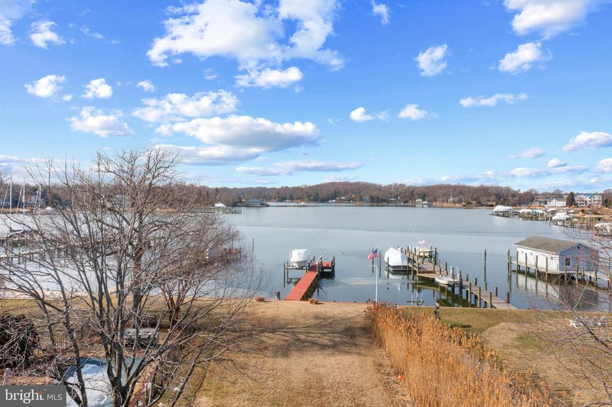 BAY RIDGE WATERFRONT! Great opportunity for a wonderful home with stunning water views of Lake Ogleton in the coveted Bay Ridge community! This 4 bedroom, 4 bath home features vaulted ceilings, screened porch, gourmet Kitchen, spacious bedrooms and private Primary Suite all with beautiful views overlooking Lake Ogleton. The light and bright main level living space is filled with natural light and features an open floor plan joining the kitchen, dining and living space all flowing effortlessly to the expansive waterside screened porch.  Spend every night watching the sunset over Lake Ogleton! The 3 bedrooms, 3 baths plus office space on this level provides plenty of room for accommodating family and guests.  The spacious Primary bedroom is located on the 3rd floor for added privacy and extraordinary views from the private balcony. The entry level boasts a full bath and the perfect entertaining space with a wet bar, cozy pellet stove, spacious deck, and direct access to the sprawling backyard that flows to the water's edge and to the private deep water dock with 6ft MLW. Enjoy fishing, swimming, kayaking and heading out on the water directly from the fully equipped pier with multiple lifts and slips; perfect for the boating enthusiast! Celebrate the waterfront lifestyle and feel like you are on vacation every day! The sought-after Bay Ridge Community features a community pool with a clubhouse that overlooks the beautiful waters of the Bay, community beaches on both the River and the Bay and a community Marina with a newly renovated clubhouse. Off-the-water activities include enjoying the basketball court, playground, ball fields, common areas and year-round community activities. Walk or ride your bike for miles along the water and enjoy all the benefits of the Bay Ridge lifestyle, there is no other place like it! Located just minutes from downtown Annapolis and Eastport which offer the perfect balance of small-town charm and big world sophistication. Traveling or commuting is just as convenient by easily accessing Rt. 50 and 97 which provides direct access to Baltimore, BWI, Ft. Meade/NSA and Washington, DC., or head over the Bay Bridge to the Eastern Shore for a quick beach vacation. Welcome Home!