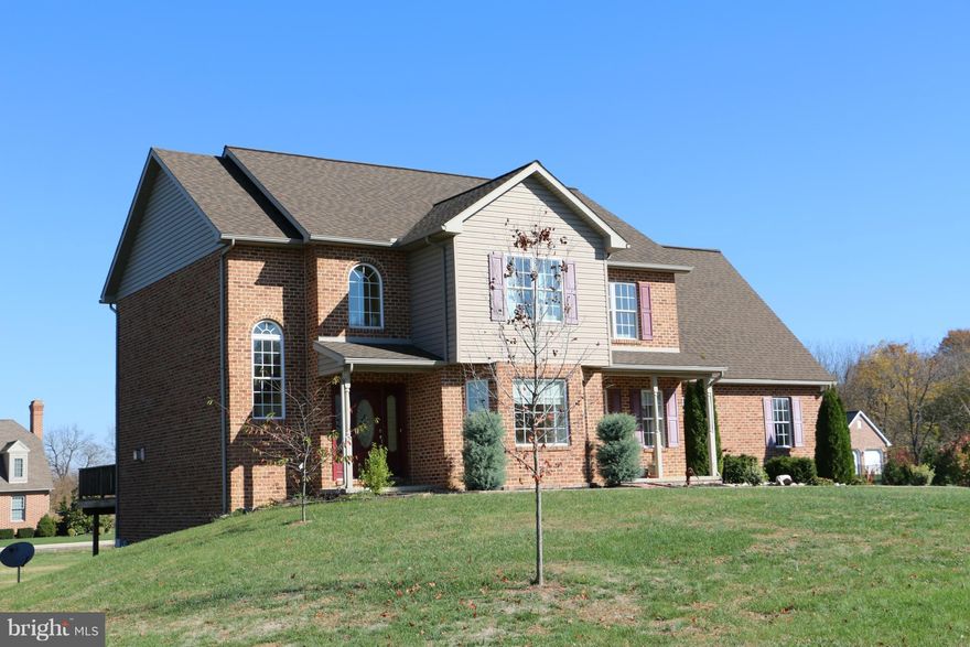 BRICK BEAUTY ON CORNER LOT IN MOSS SPRING ESTATES - 3-4 CAR GARAGE (10' DOOR HGT), OPEN FLOOR PLAN,  HDWD & LAMINATE FLOORS, TILED BATHROOMS, MAIN LEVEL LAUNDRY, 2-STORY FOYER, LIV & DINING ROOMS, FAMILY RM W/GAS FP AND WALL OF WINDOWS. FULL UNFINISHED WALK-OUT BSMT W/EXTRA WINDOWS (PLUMBED FOR BATH)...IMAGINE THE POSSIBILITIES. LRG REAR DECK & PATIO, NICE LEVEL LOT OVER 1/2 ACRE AT EDGE OF TOWN.