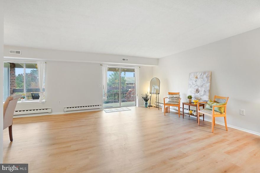 Spacious top floor unit with a beautiful view of the green space beyond and afternoon/evening sun sets. Many updates throughout including all new laminate floors in main living space and cozy carpet in the bedrooms. Unit has been painted throughout and lovely light curtains surround the windows.  All fixtures have been replaced including overhead lighting fixtures, door handles and cabinet pulls.  Unit has been thoroughly cleaned and windows washed.  The coffee bar off the kitchen is a great gathering spot for entertaining and brewing your favorite beverage any time of day. Kitchen is bright with a window over the kitchen sink.  Darker wood cabinets offset the bright white countertops. Side by side washer/dryer are behind sliding doors across from the pantry in the kitchen. Move in Ready.