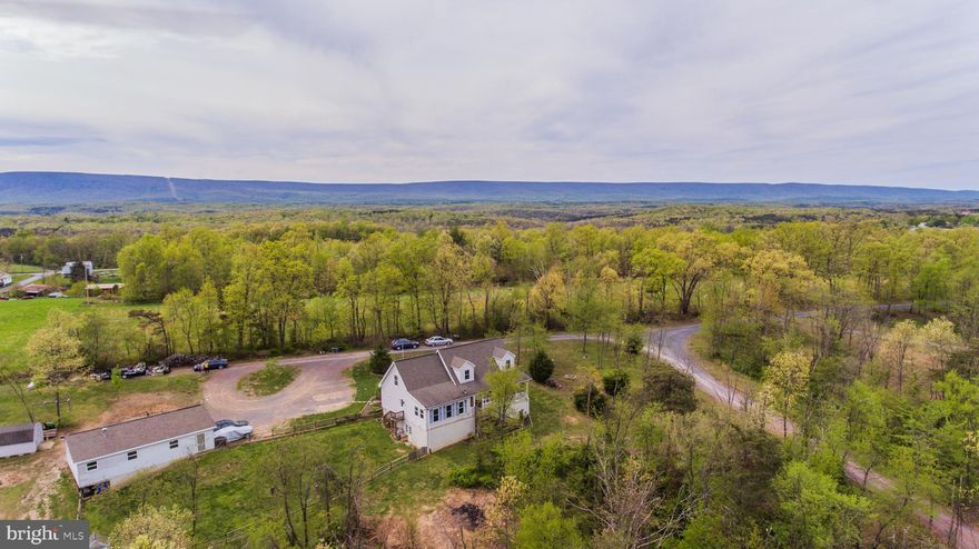 Motivated Sellers. Let's help these Sellers move this summer.  The House is a must see when looking for a  Large, Spacious Cape Cod Home with 6x32 front porch, 3-5 bedrooms on a private, 4.01-acre lot on a dead-end road, 400 amp service Wowzer,  2 upper bedrooms, one with walk-in closet, huge upper bathroom offers a Jacuzzi tub. Main level offers a spacious kitchen, 20x13 living room, den/office, sun room with pellet stove, bedrooms, wood floors in the foyer, wooden staircase, separate dining room for those big gatherings. Move in Ready. Bring your own plans to finish the mostly unfinished basement. Detached 2 car garage. Easy commute to the Winchester area.  Sellers will pay $5,000.00 towards Buyer's closing costs.