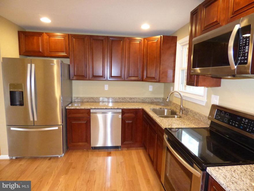 Fantastic Split Foyer on half acre, All New Kitchen w/granite counters, new soft close cabinets, ss appliances & ceramic tile. New natural Hardwood Floors on main level w/big bay window. New carpet & all fresh paint. Both Full Baths remodeled! Huge Family Room w/picture window.  Newer windows & roof. New water heater. Recessed lights, crown molding, big deck & new washer & dryer! Great Location!!!