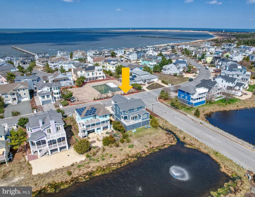 Steps to the beach and Delaware Bay in Cape Shores!  This custom home was built in 2017 and backs to a community pond with fountain and is situated on a large corner lot.  Shows like a model home and comes fully furnished, decorated, and ready to enjoy this summer!  It also includes all the toys you will need to enjoy summer - boat, two jet skis, kayaks, paddle boards, & a golf cart!  Welcoming entry foyer leads to open concept floor plan with gourmet kitchen, great room, and dining room.  Great room features gas fireplace with built-ins, coffered ceilings, hardwood floors and quadruple slider out to wrap around screened porch.  The gourmet kitchen features granite counters, tile backsplash, stainless appliances, hardwood floors, pantry closet, and KraftMaid tongue and groove cabinetry. The dining room has plantation shutters and French doors out to the wrap around screened porch.  The owner's bedroom suite has hardwood flooring, custom window treatments, personal laundry room, walk-in closet, sliders to back deck overlooking the pond, and beautiful bathroom with jacuzzi tub, tile shower, and double sinks with beautiful granite and tile. This main level is completed by a powder room, elevator, and second access door to the back deck overlooking the pond.  The second level features a large family room (could be bedroom 5) with sliders to a covered porch with nice views of the Cape Shores community space with pool.  There are three additional bedrooms, two full bathrooms, and a laundry room on this second level.  All the rooms feature hardwood flooring and the bathrooms feature tile floors. The ground level is a large garage & storage area with parking for three + cars with two electric car chargers, boat and jet ski parking, shed for tools, outdoor shower, and two people access doors and garage door with opener.  The large garage/storage space totals 1,889 feet.  There is also a mudroom, wine room, and storage room on ground level with elevator access to all levels.  Take the golf cart to the community beach, pier, pool, tennis, or pickleball courts!  Easy bike ride to Henlopen State Park, downtown Lewes restaurants & attractions, &  Lewes Rehoboth Canal!  Located steps to the Capes Shores beach and next to Cape Henlopen State Park! Start enjoying Lewes beach life this summer yourself or maximize the excellent rental potential this home offers.  Take the video tour!