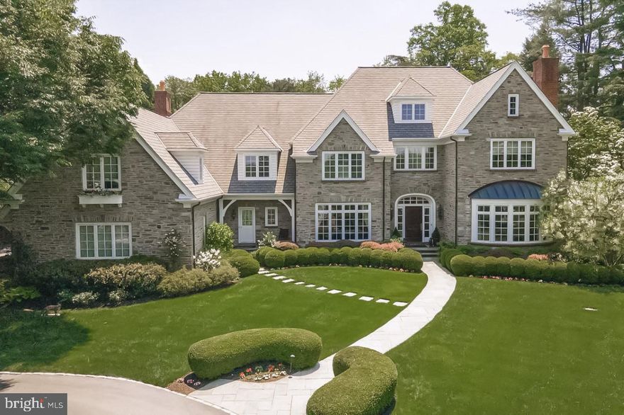 Here is your opportunity to own a masterpiece home situated on one of the Main Line’s most desirable streets.  Lushly landscaped grounds designed by a Landscape Architect, surround the property creating a tranquil ambiance of privacy.
Designed by esteemed architect Michael Visich, this home was constructed with the highest quality materials by master builder Ken Casella. Old world charm blends seamlessly with a spacious, modern floor plan. This 5 Bedroom, 6 .2 bath estate gem has gorgeous Hardwood floors, moldings and wainscoting throughout.
Upon entering the spacious entrance hall, you have front to back windows with outstanding views. An elegant formal living room with a large bay window and gas fireplace is on your right.  A wall of windows overlooking the front gardens provide an extra special setting for the formal dining room on your left. A convenient mahogany butler’s pantry/wet bar adjoins. A stunning walnut library with large bay windows and gas fireplace has spectacular backyard views. A professional style gourmet kitchen features white cabinetry, a sumptuous 10 ft center island, granite counter tops and nickel-plated backsplash.  A 6-burner stove; double dishwashers and warming tray make for effortless entertainment. Adjoining the kitchen is a large breakfast area featuring beautiful palladium windows overlooking the grounds Double glass doors exit to a large slate patio with spectacular views of the heated pool, spa and Pergola.
 The oversized family room has a coffered ceiling, beautiful built-ins and plenty of natural daylight. Completing the fist floor are dual powder rooms and a mudroom leading to the 3-car garage.
Upstairs. The palatial primary suite is bathed in sunlight from the beautiful bay windows. A spa like ambiance awaits providing the perfect retreat to the extensive dressing area with Cherry wood floors, a magnificent cast iron tub, Calcutta marble steam shower, double vanities and large his and her closets. Four additional en-suite bedrooms, hallway workspace with built-ins and a large laundry room complete the upper level.
The lower level, containing natural light showcases a copper topped mahogany wet bar, a connoisseurs 1000 bottle wine room along with billiard and entertainment area. The professionally equipped gym, full bath and sauna make staying in shape a pleasure.
A full house generator and security system provide peace of mind.
This exceptional home, close to the village of Gladwyne is located in Lower Merion School district, minutes from center city and close to all major arteries.