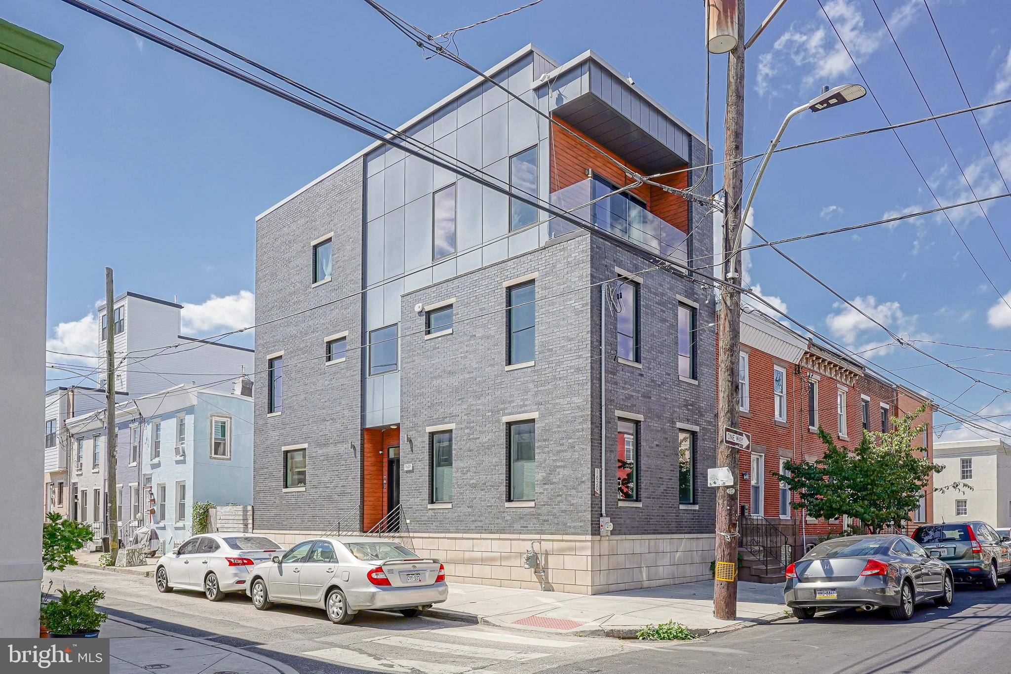 With years remaining on a tax abatement, this 3,000 square foot corner home in Point Breeze delivers contemporary design and everyday luxury just steps from Broad Street and the East Passyunk dining corridor. Soaring 10-foot ceilings, hand-scraped bamboo floors, custom millwork, and an open layout highlight the main floor, where a chef’s kitchen shines with a waterfall island, herringbone tile backsplash, wall oven and microwave, full Samsung stainless suite, and a Viking stove. The king-size primary suite features a private wet bar, large walk-in closet, and spa bath with a freestanding soaking tub and a multi-head glass-enclosed shower, while each guest bedroom offers its own walk-in closet and a second-floor office adds flexibility. A full laundry room is also conveniently located on the second floor. The finished lower level provides space for a media room, gym, or guest suite, and the home is capped by a massive roof deck with skyline views that can be enjoyed from the living room up through the roof deck, along with built-in speakers and a backyard for grilling and entertaining. Smart-home touches include a Nest thermostat, smoke detectors, Google doorbell, keyless entry, security cameras, and a SimpliSafe system for comfort and peace of mind. The location puts you less than a block from the SEPTA #2 bus with direct access to Center City, within a seven-minute walk to three parks, a five-minute walk to coffee shops including Mighty Bread, ReAnimator, and Green Street, and under ten minutes to three different grocery stores. You are also just blocks from the Broad Street Line and within walking distance of neighborhood favorites like South Philadelphia Tap Room, American Sardine Bar, Dock Street Brewing, and the acclaimed East Passyunk Avenue dining scene with Ember & Ash, Le Virtù, Barcelona Wine Bar, and more.