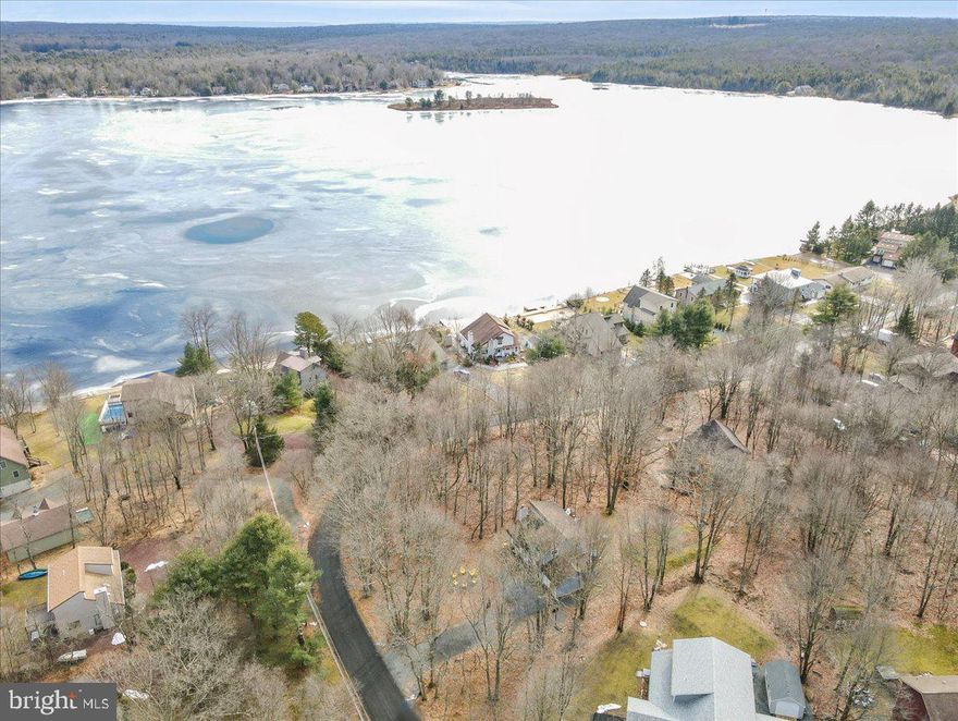 LAKEVIEW! Across the street from the community lake at Towamensing Trails, sits this modern 3 bedroom, 2 full bath cozy-chic mountain getaway. Enjoy the outdoors with THREE decks to take in the LAKE VIEWS and spacious yard w/ firepit. Bright and open concept GREAT ROOM w/ vaulted ceilings, stone fireplace, exposed beam, and fully stocked modern kitchen w/ granite. Bonus game room & loft areas add to the lounge spaces. Active Short-Term Vacation rental being sold Turn-Key & FULLY FURNISHED with bold & fun decor and chic modern furniture that stands out. Minutes from Jack Frost Big Boulder skiing, Hickory Run State Park & other mountain attractions. Walking distance to the community beach and amenities such as clubhouse, lake, outdoor pool, tennis court, and playground. This home has it all! Schedule to see it this week!