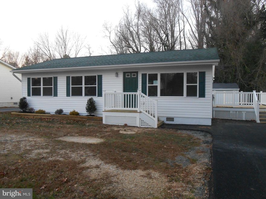 Totally rebuilt from the studs up - like brand new, nothing to do but move in! Nice upgrades include granite counters and stainless appliances. Super side deck for outside enjoyment.  This is a water-access community with beach & community pier.  Optional pool membership $330/year.