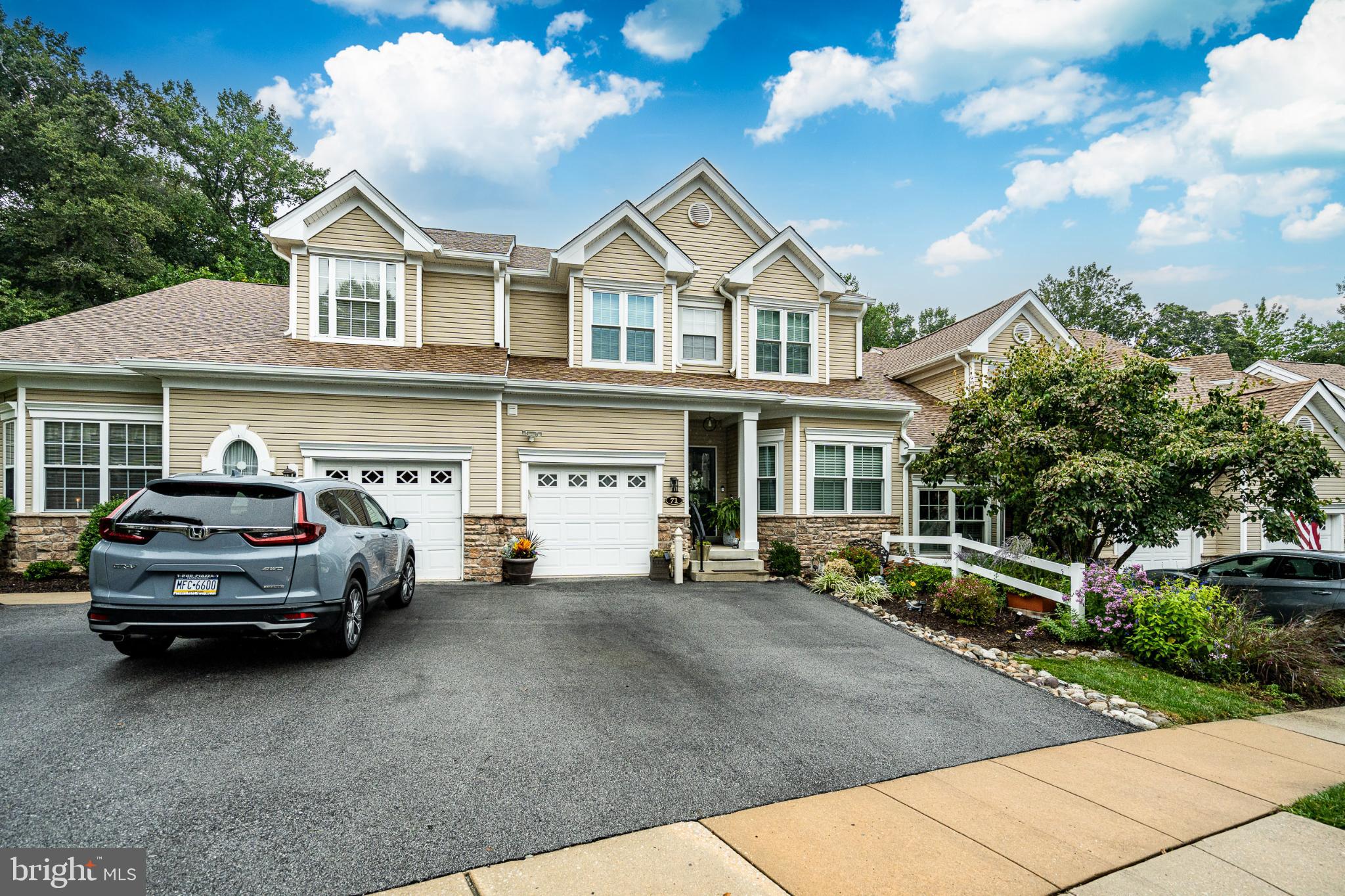 Nestled within the serene and vibrant community of Creekside Village, this exquisite townhouse offers an unparalleled lifestyle for those seeking comfort and elegance. This home is the largest model boasting 2,621 square feet above ground plus the additional finished basement. As you step inside, you are greeted by a warm and inviting atmosphere, accentuated by the rich hardwood flooring and plush carpeting that flow seamlessly throughout the living spaces. The gourmet kitchen is a culinary enthusiast's dream, featuring high-end appliances including a built-in microwave, range, and dishwasher, all designed to elevate your cooking experience. The living area is anchored by a cozy gas fireplace, perfect for those cooler evenings, creating a focal point for relaxation and gatherings. With three well-appointed bedrooms and two and a half bathrooms, this home offers plenty of space for both privacy and entertaining. The open floor floor plan is perfect for entertaining. Open kitchen, dining area and living space with sliders to new maintenance free deck. The primary suite is complete with be spacious bedroom, sitting area, walking closet and full Bathroom. Primary bathroom has double sink and ceramic tile walk in shower. As you enter the home there is an additional room that some use as a bedroom or tv room. The main floor laundry adds to the convenience, making daily tasks a breeze. The upper level has Loft area plus 2 additional bedrooms, office and full bathroom. The lower level is a full walk out basement with sliders to patio. Plus additional storage area or work shop. Step outside to discover your personal oasis. The exterior features include beautifully maintained landscaping and inviting outdoor spaces, including a deck and patio, ideal for enjoying morning coffee or evening sunsets. The community amenities are truly exceptional, featuring a clubhouse, fitness center, outdoor pool, tennis courts, and more, all designed to foster an active and engaging lifestyle. The property adjoins open space, providing a tranquil backdrop of trees and woods, enhancing the sense of peace and privacy. An attached garage with inside access ensures your vehicle is protected, while the asphalt driveway offers additional parking for guests. Creekside Village is not just a place to live; it's a community that promotes a fulfilling lifestyle. With maintenance-free living, including lawn care and snow removal, you can spend more time enjoying the amenities and less time on upkeep. This home is a rare find, combining luxury, comfort, and a vibrant community atmosphere, making it the perfect place to call home. Experience the exclusive lifestyle that awaits you in this remarkable property. This home has been well maintained with new windows, new heater and ac, upgraded lighting, roof has been replaced since home has been built.