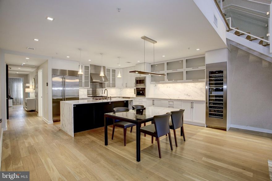 Stunning designer penthouse with direct elevator access and private roof terrace in sought-after Gaslight Square. Custom upgrades throughout such as dramatic two-story gas fireplace and surround, custom window treatments, extended kitchen with white cabinets, chef-caliber appliances, marble island with waterfall edge, wine refrigerators, direct gas line to grill on terrace, etc. Floating glass staircase to upper level loft, bedroom suite and roof terrace. Smart home with Control4 system that integrates lighting, window treatments & Audio/Video. Two garage parking spaces included.